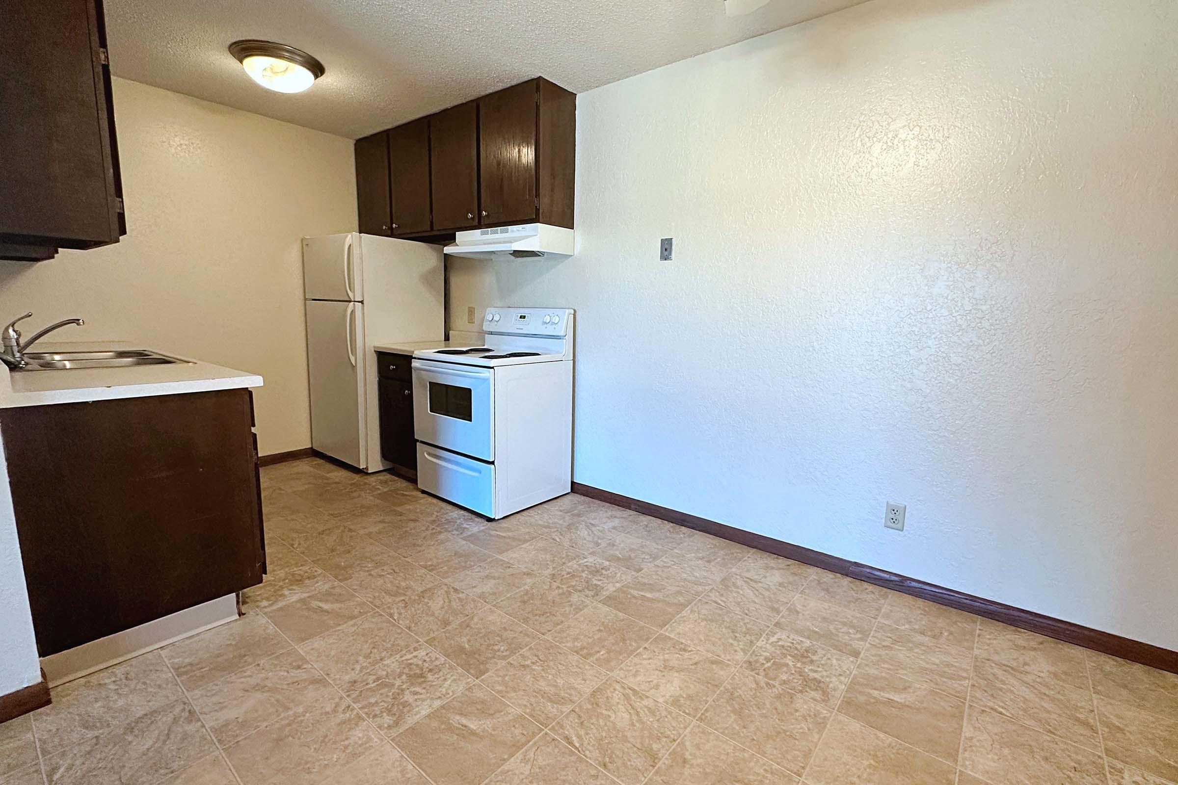 a kitchen with a sink and a refrigerator