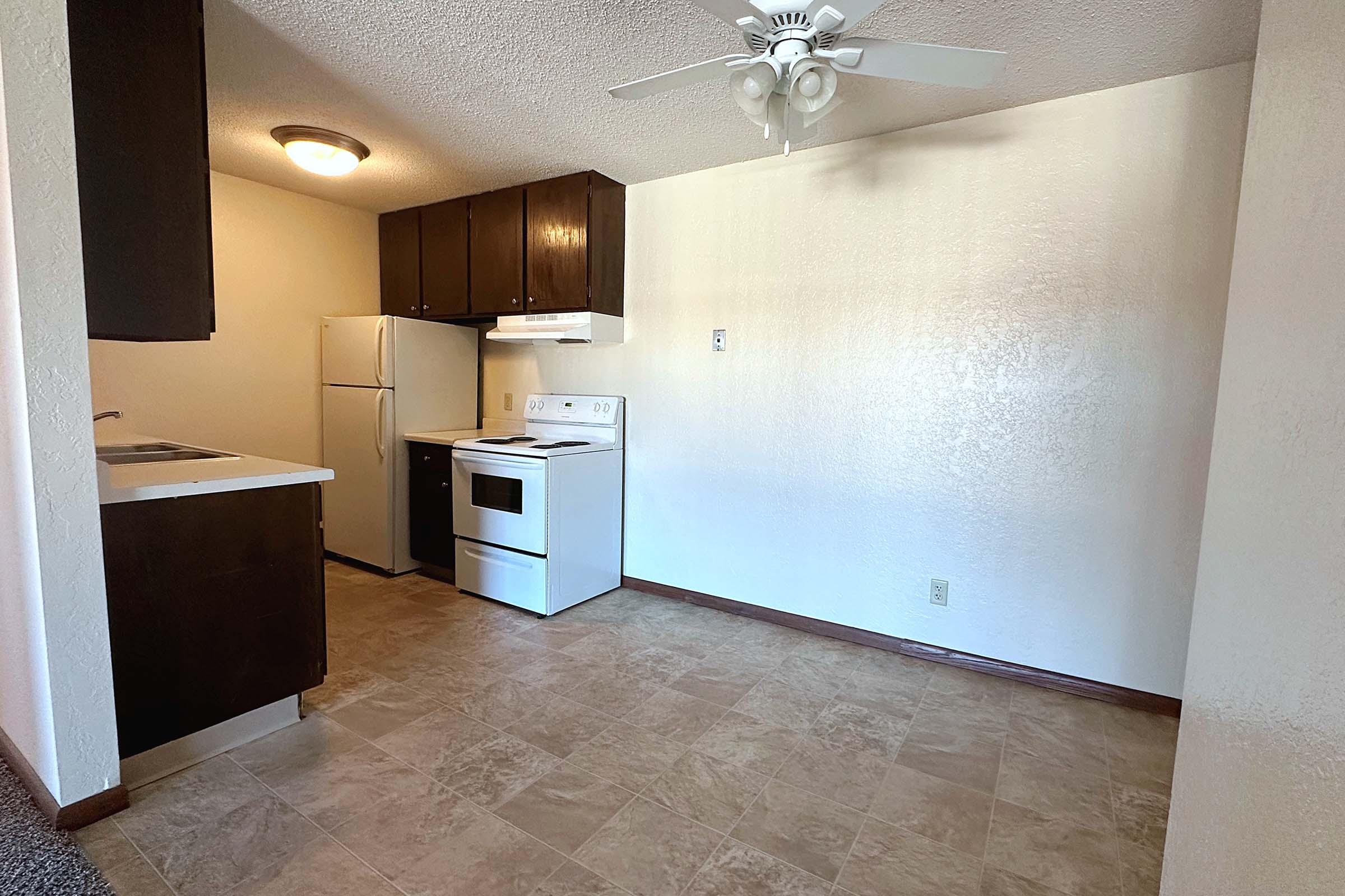 a kitchen with a sink and a refrigerator