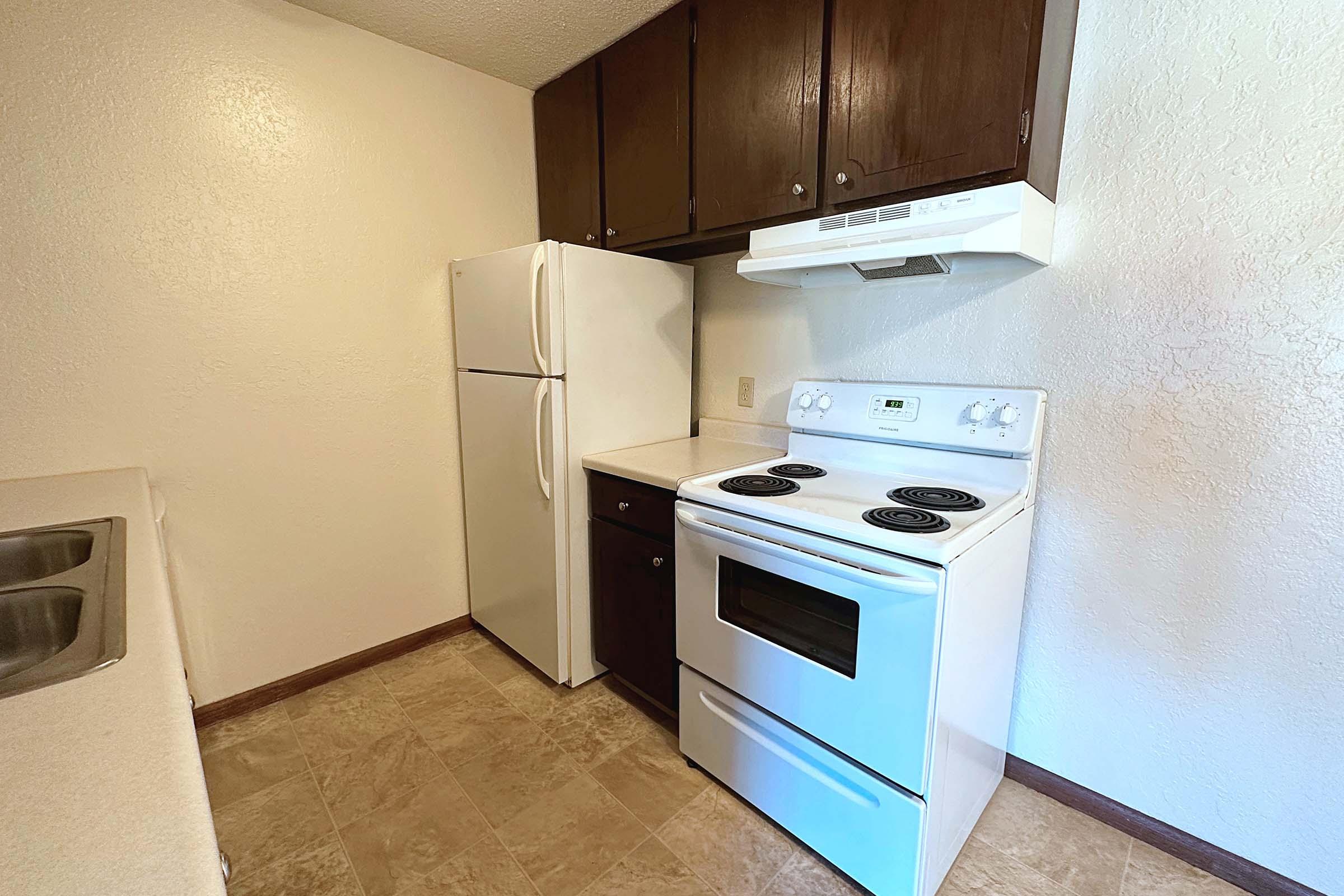 a kitchen with a stove top oven sitting inside of a refrigerator