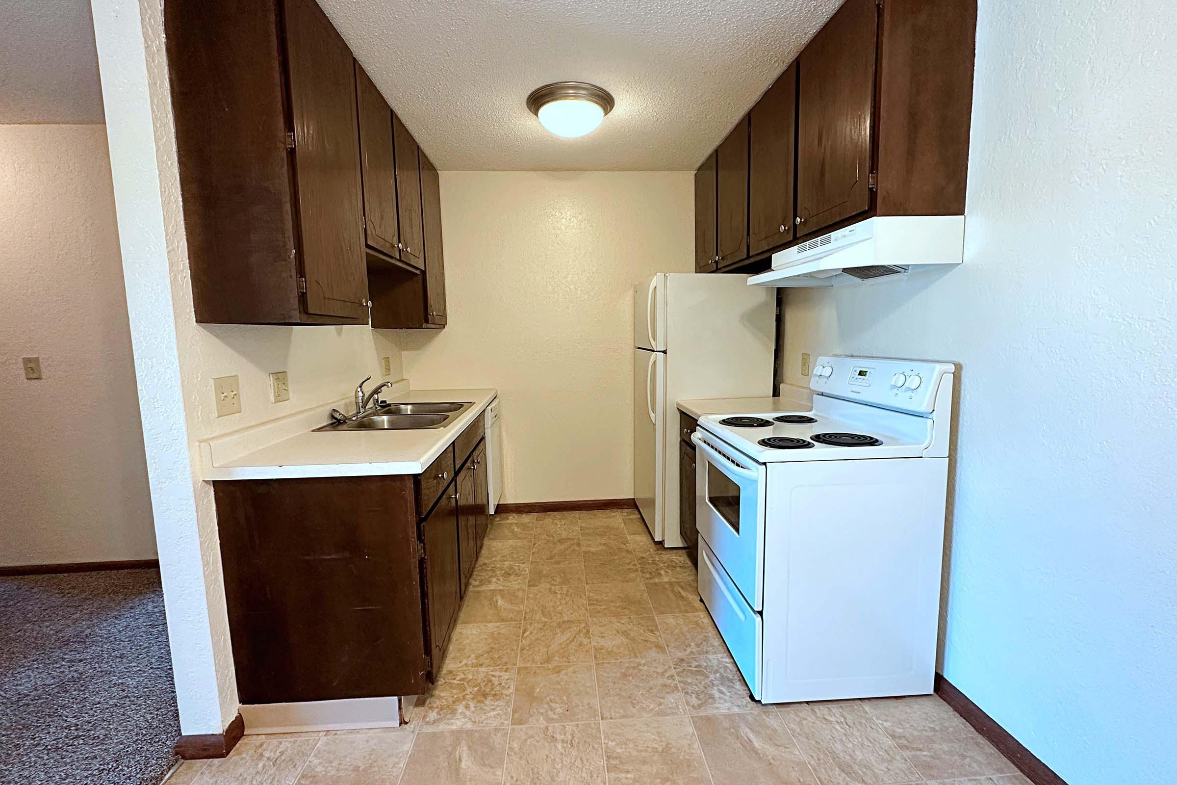 a kitchen with a sink and a refrigerator