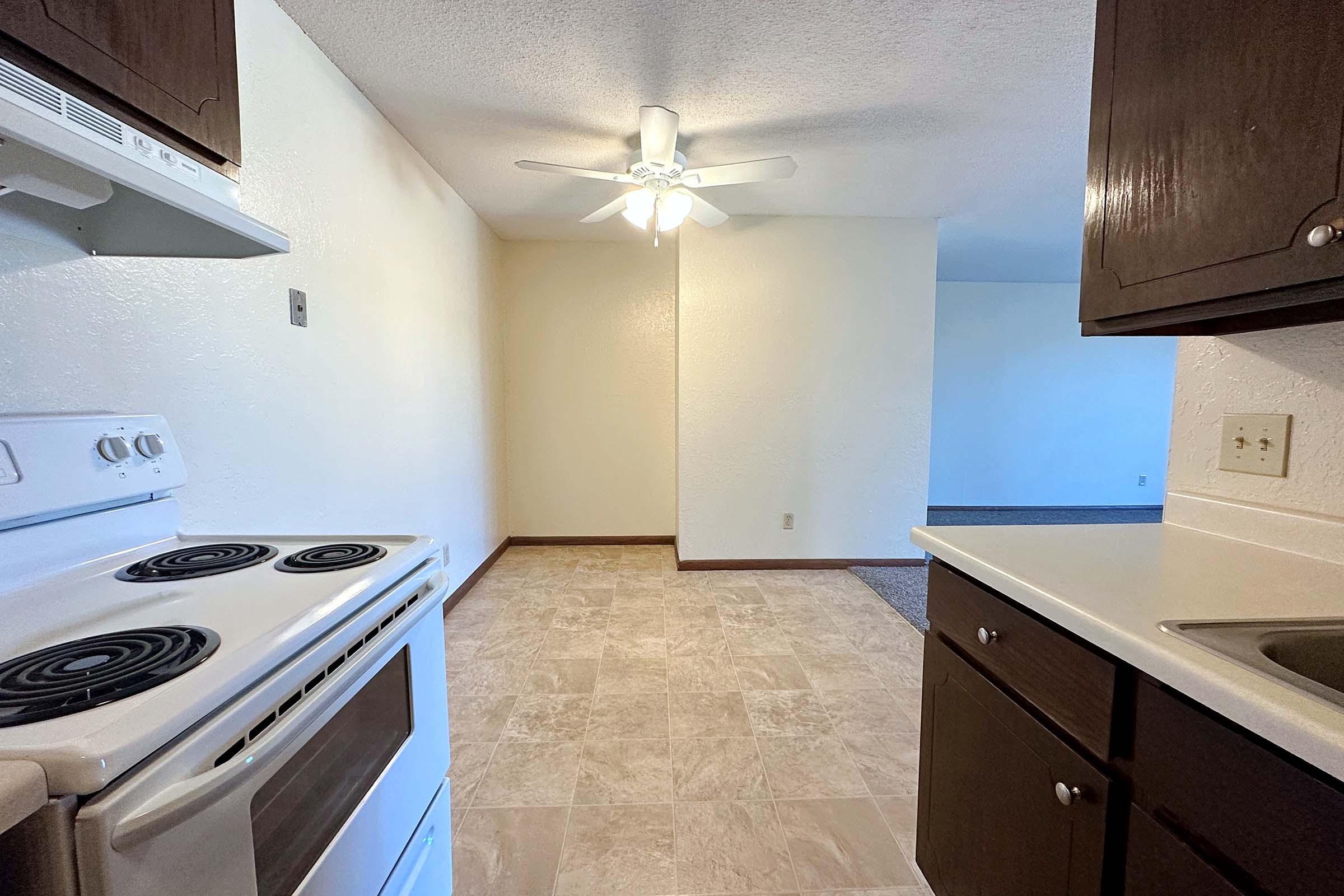 a stove top oven sitting inside of a kitchen