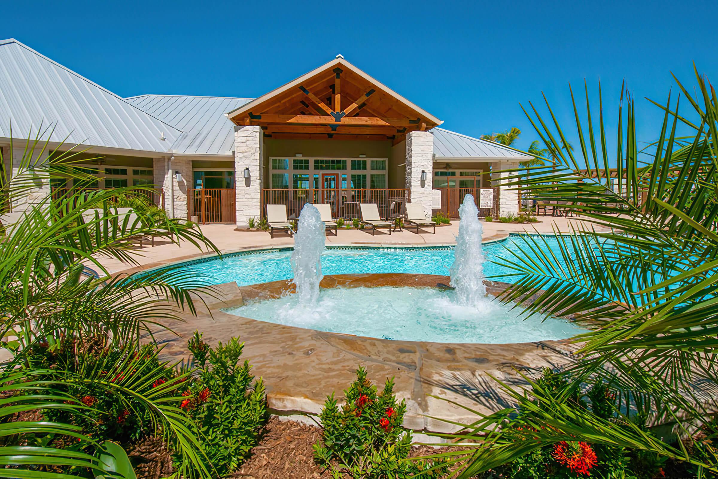 a house with a pool in front of a building