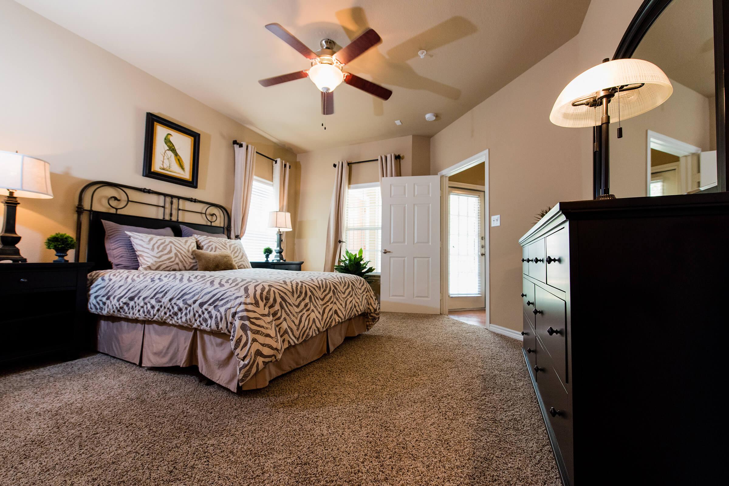 a bedroom with a bed and desk in a room