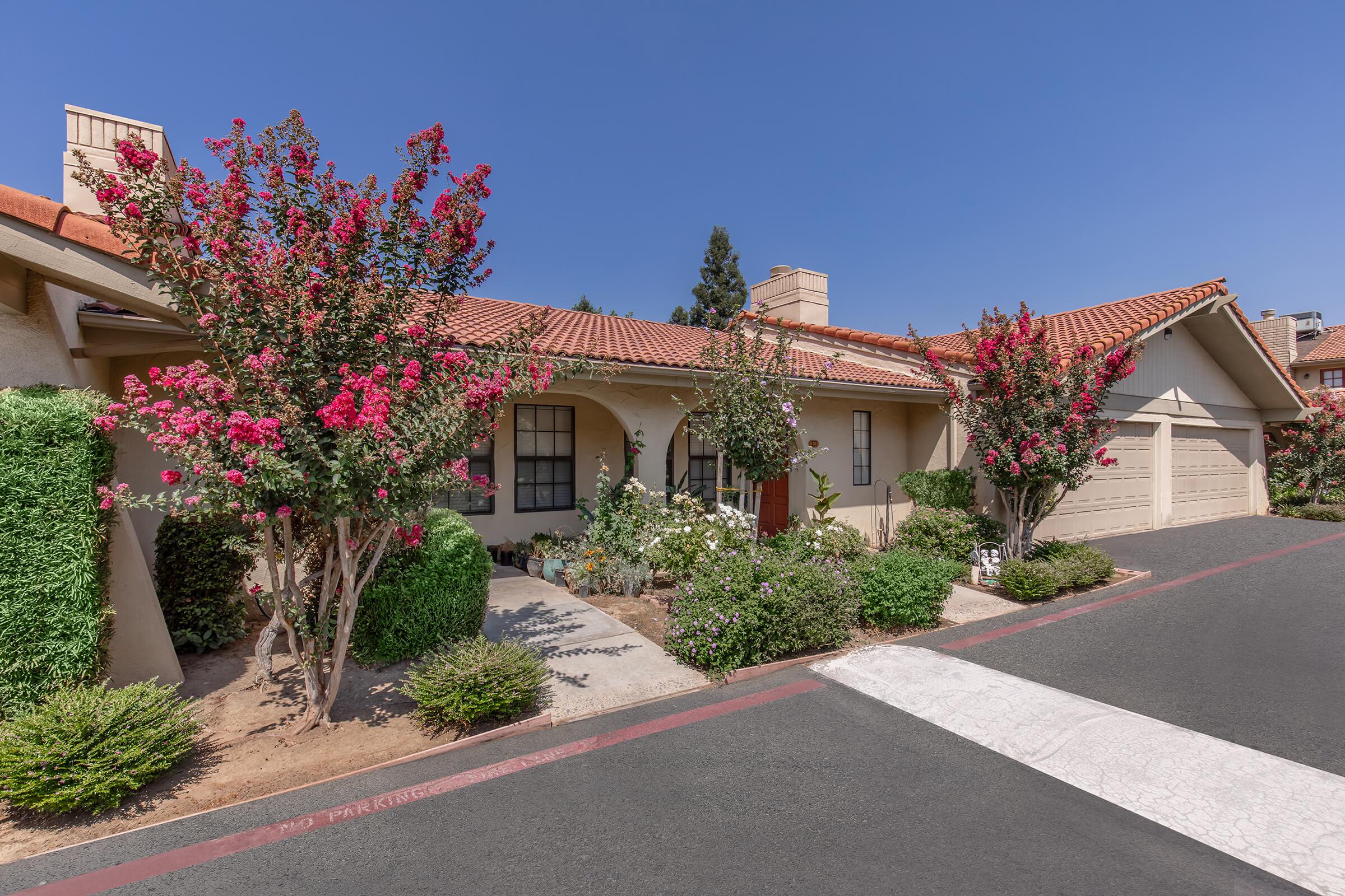 a house with bushes in front of a building