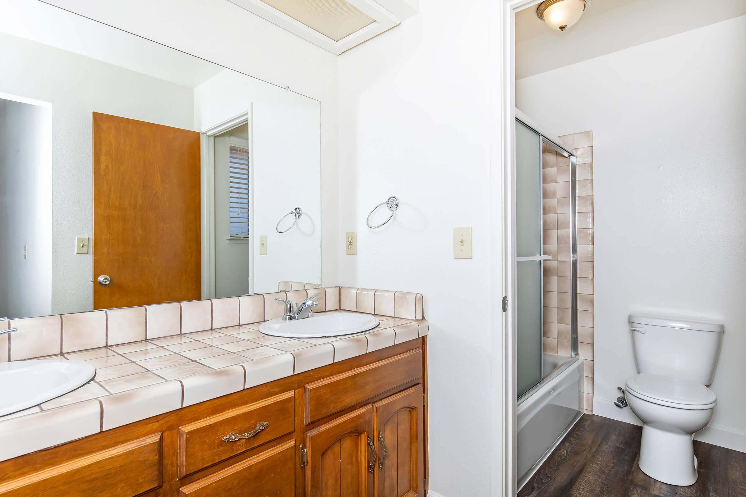 a kitchen with a sink and a mirror