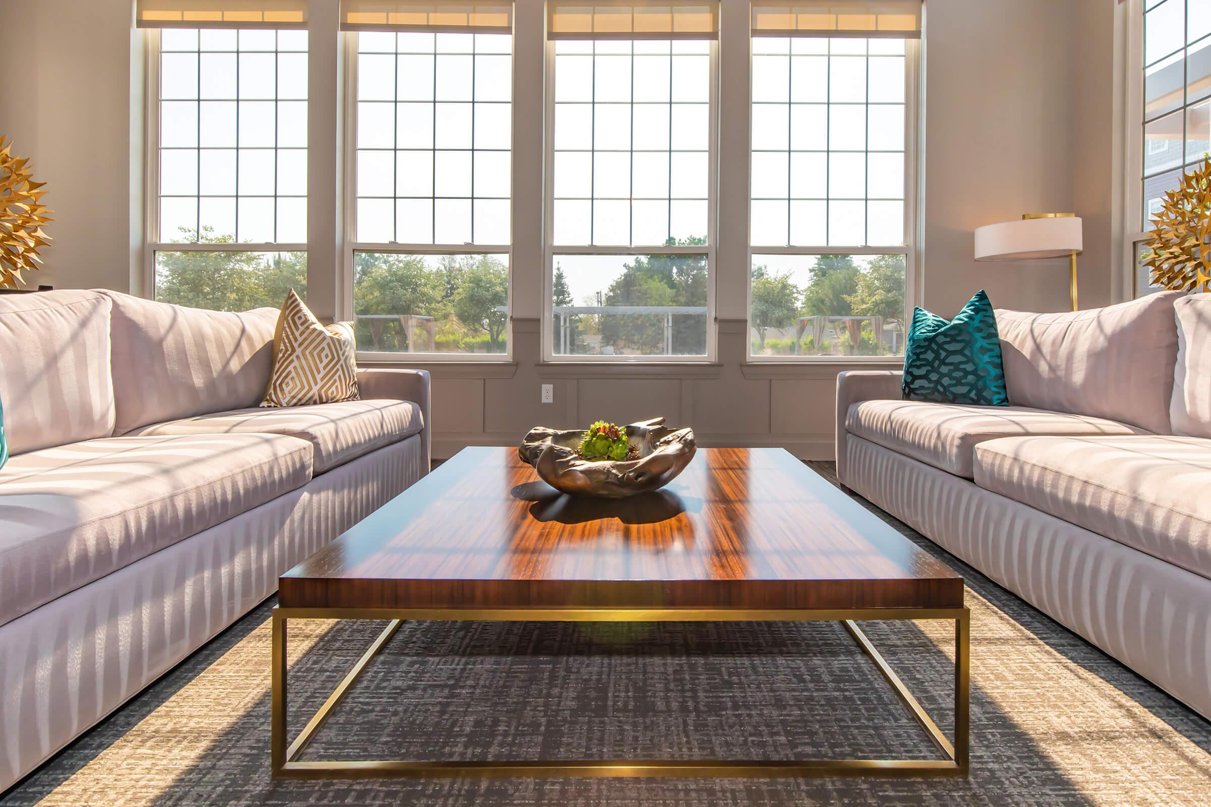 a living room filled with furniture and a large window