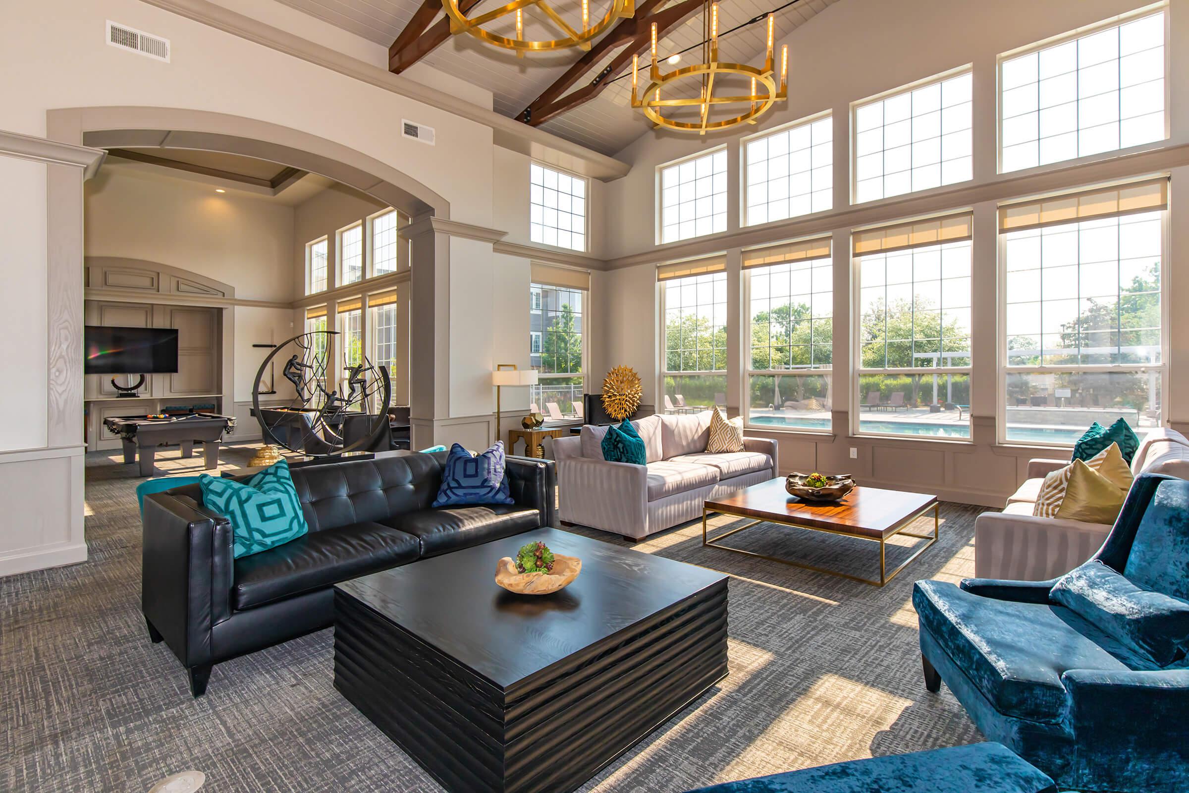 a living room filled with furniture and a large window