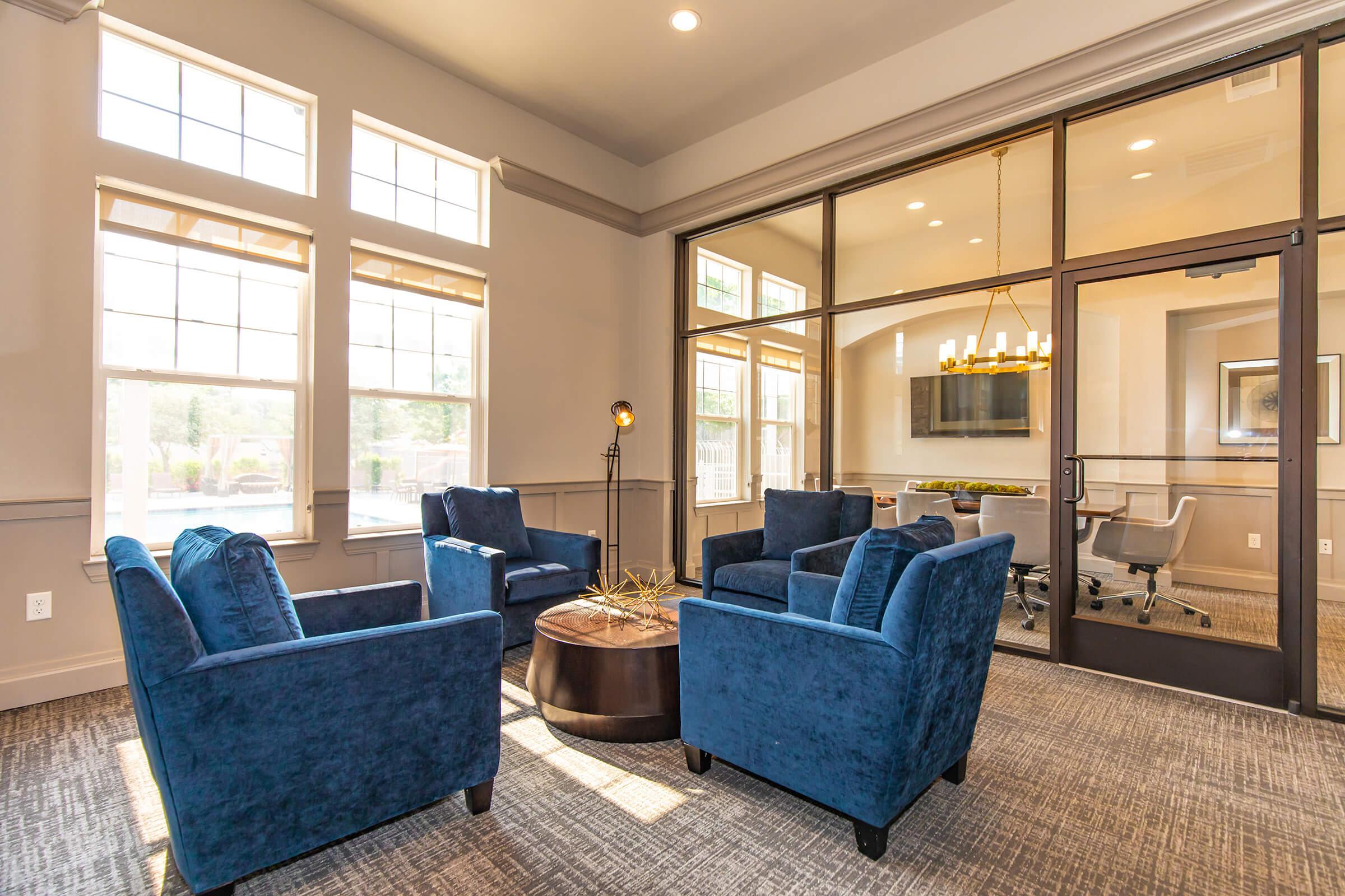 a living room filled with furniture and a large window