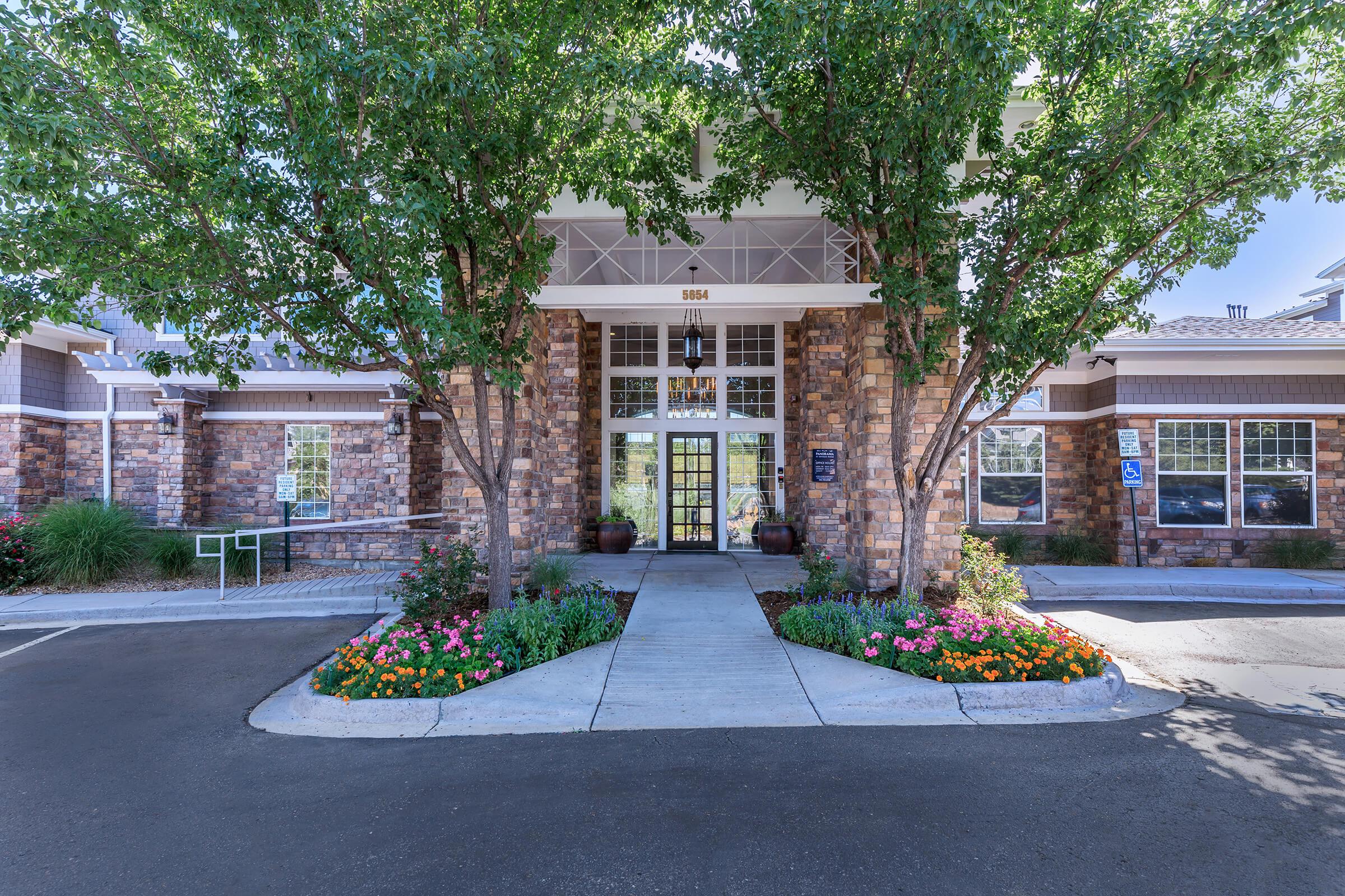 a close up of a flower garden in front of a building