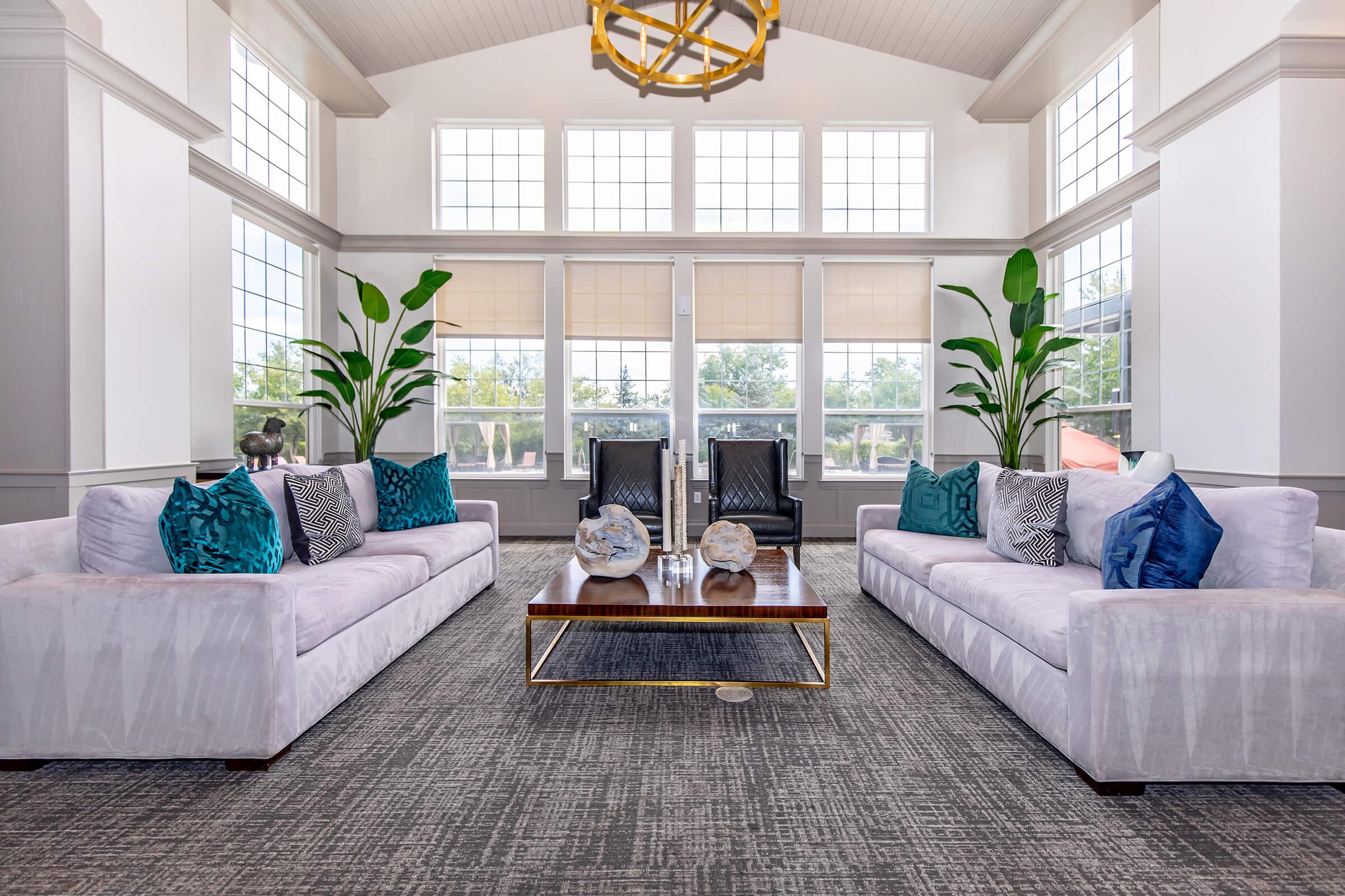 a living room filled with furniture and a large window