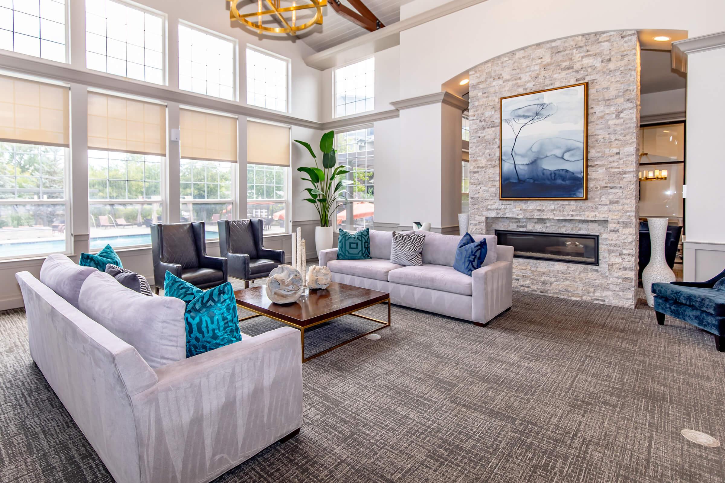 a living room filled with furniture and a large window