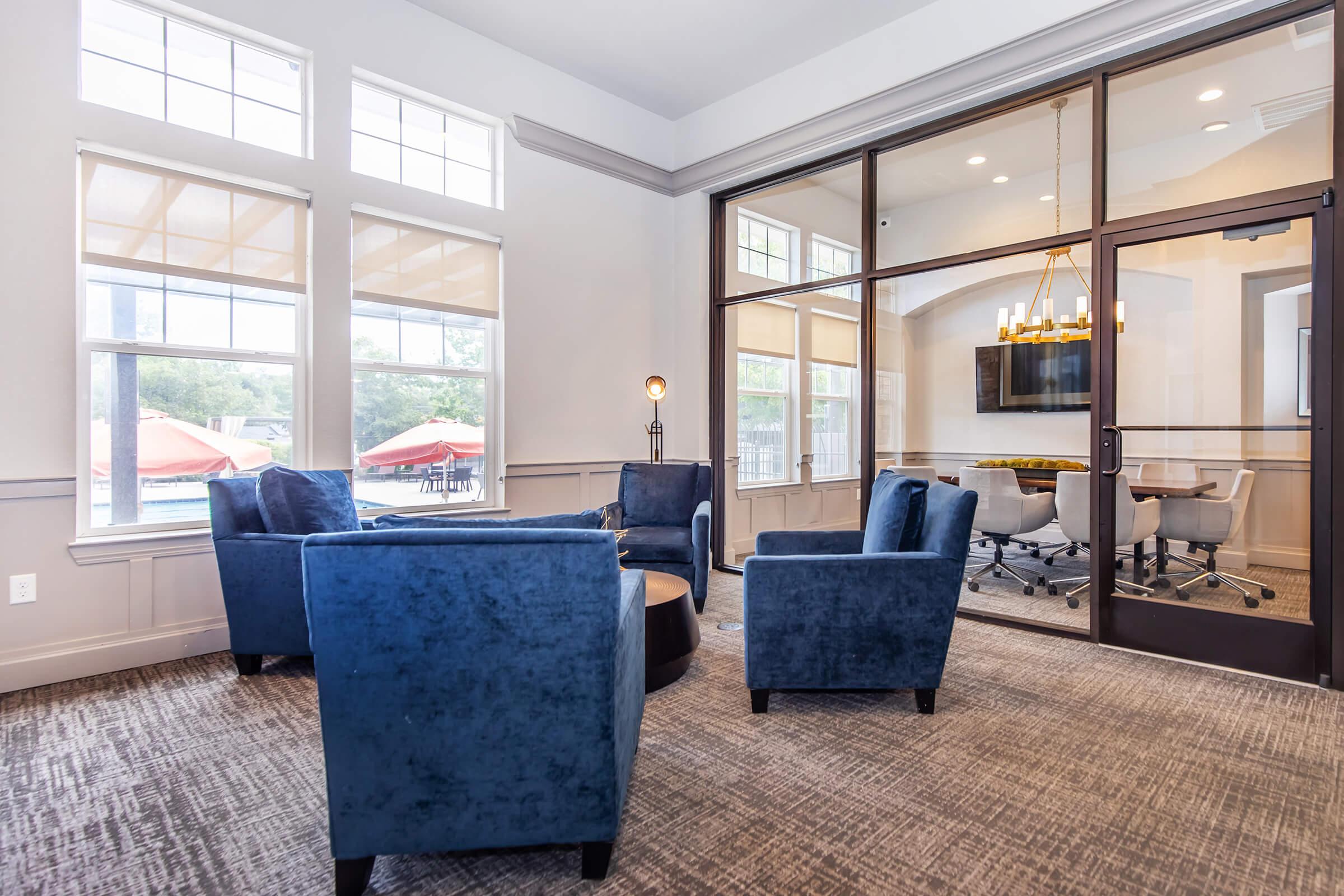 a living room filled with furniture and a large window