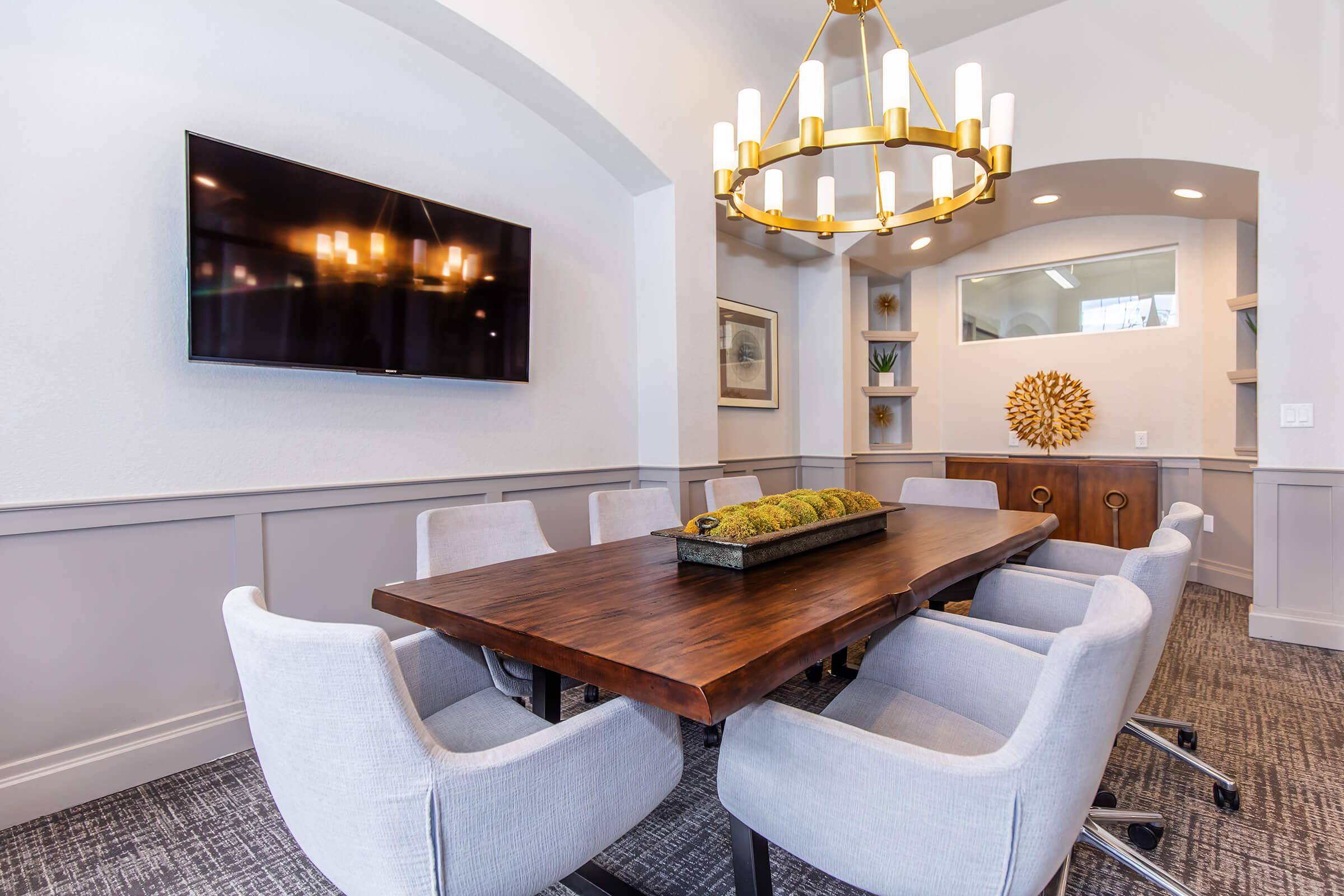 a kitchen with a table and chairs in a room