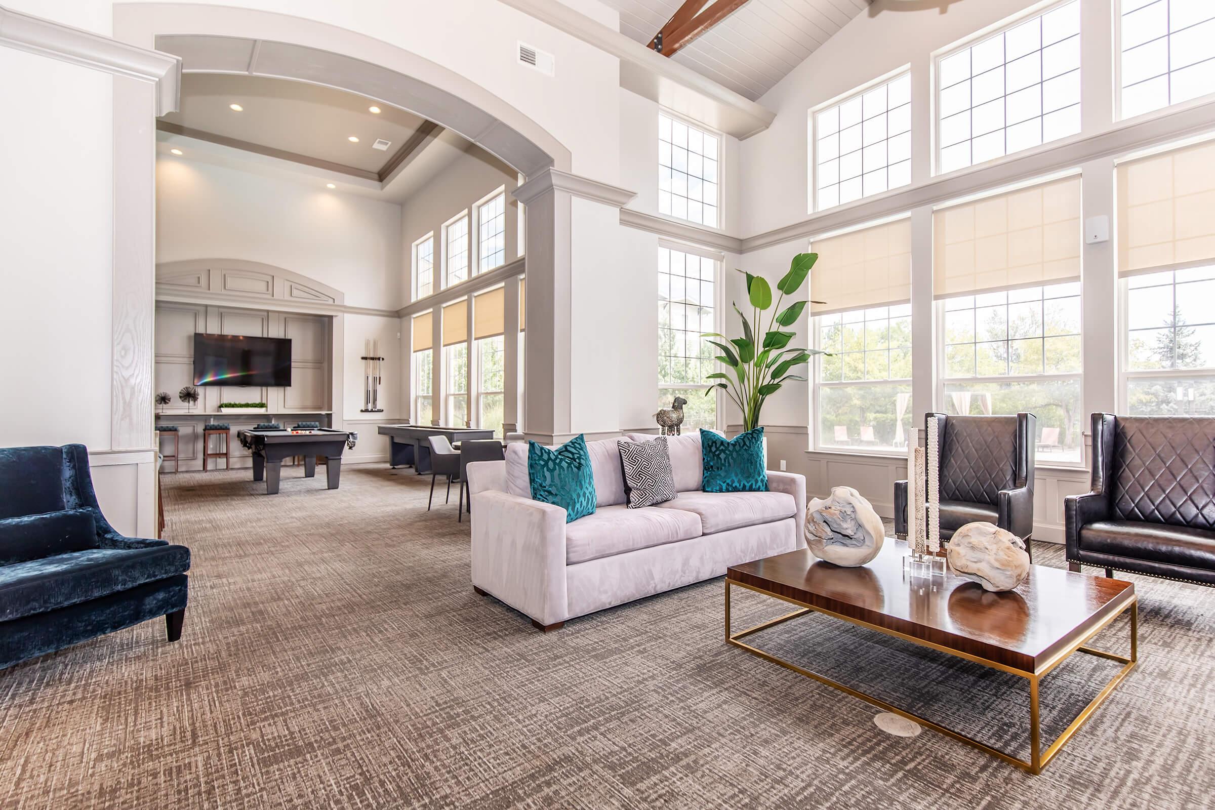 a living room filled with furniture and a large window