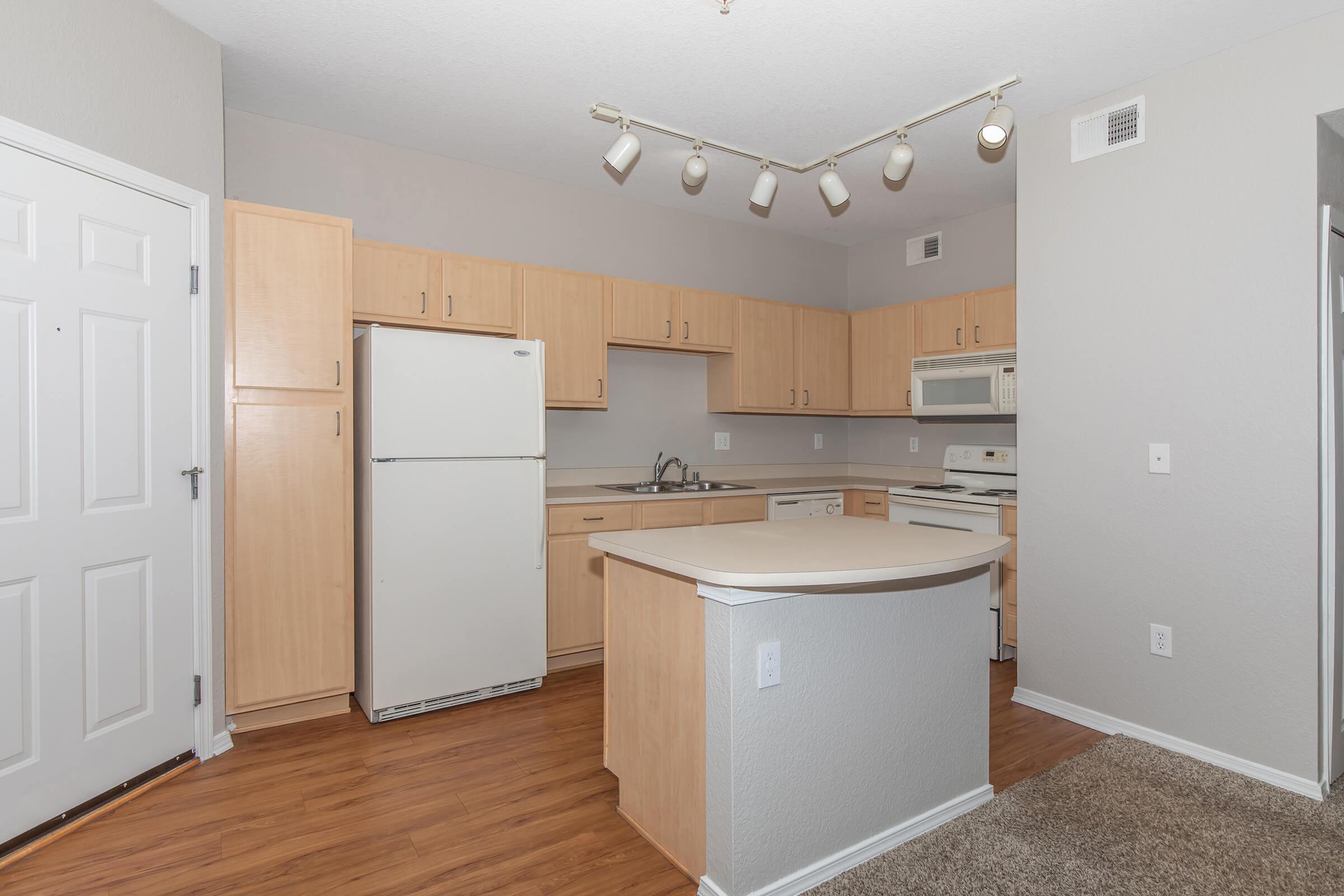 a kitchen with a sink and a refrigerator