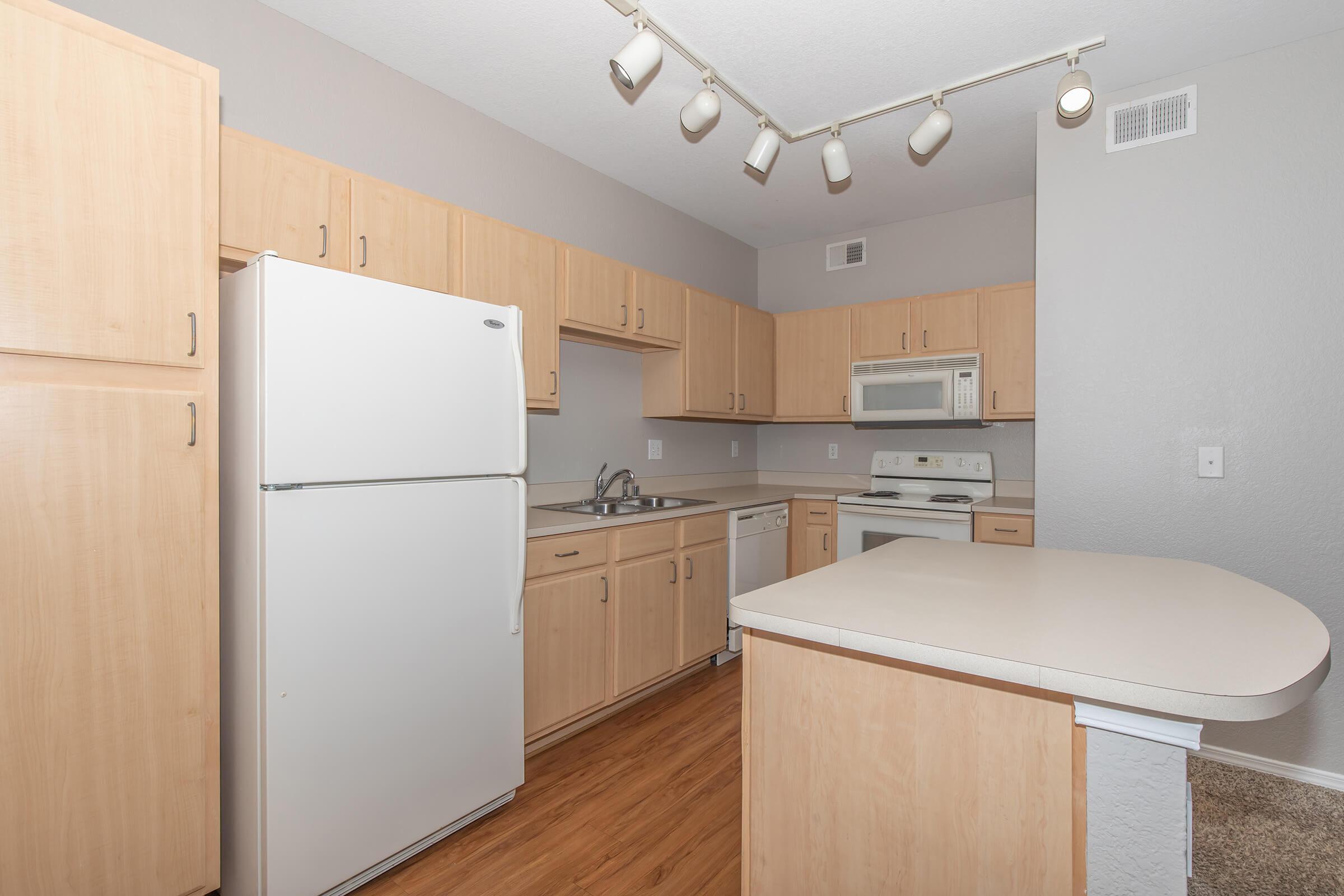 a kitchen with a stove and a refrigerator