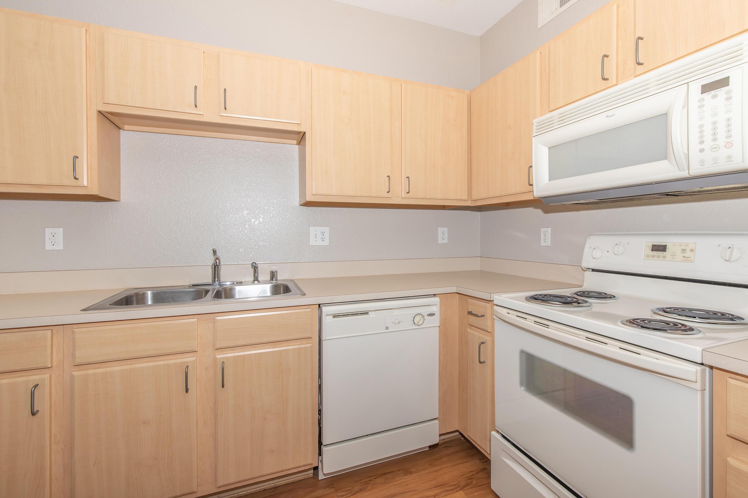 a stove top oven sitting inside of a kitchen