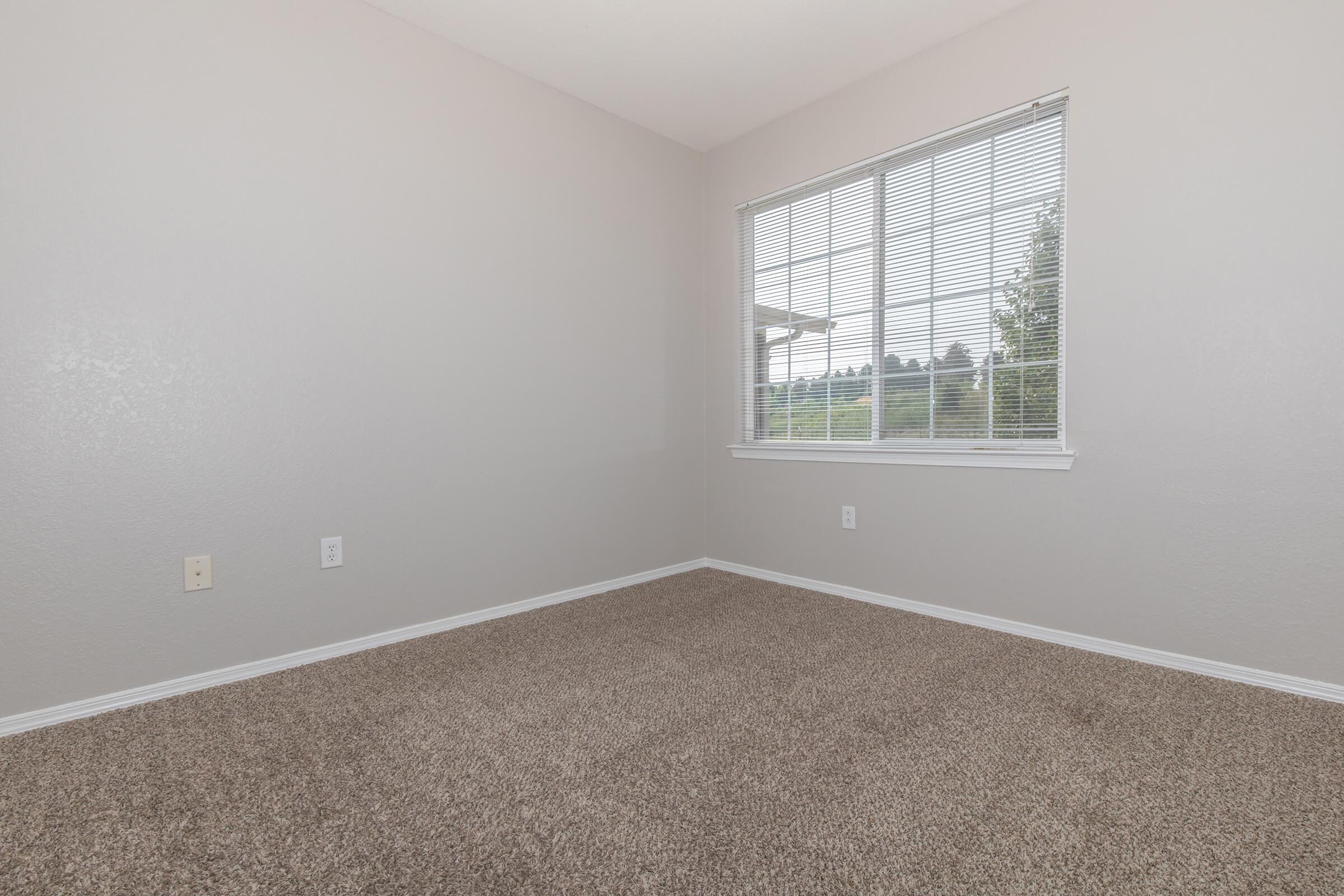 a bedroom with a large window