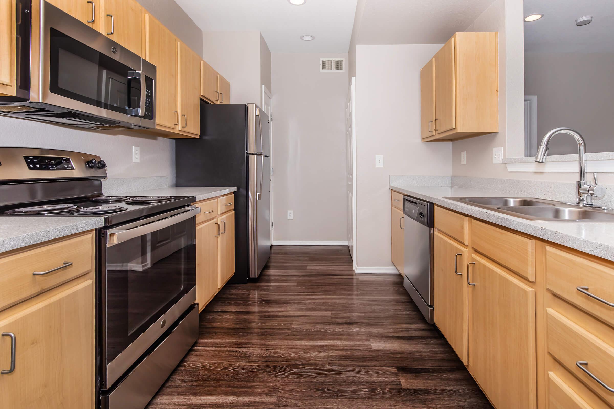 a stove top oven sitting inside of a kitchen