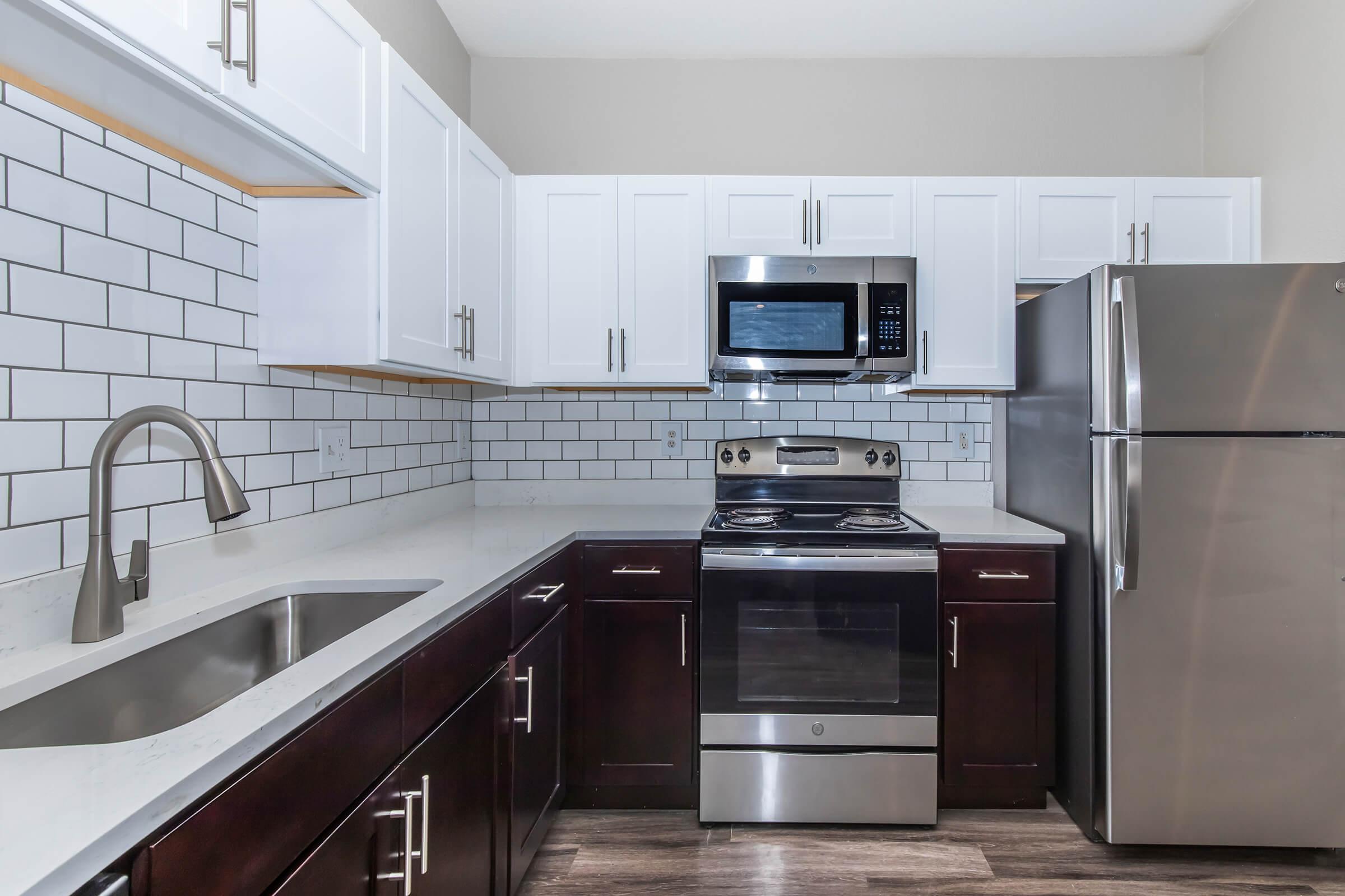 a stove top oven sitting inside of a kitchen