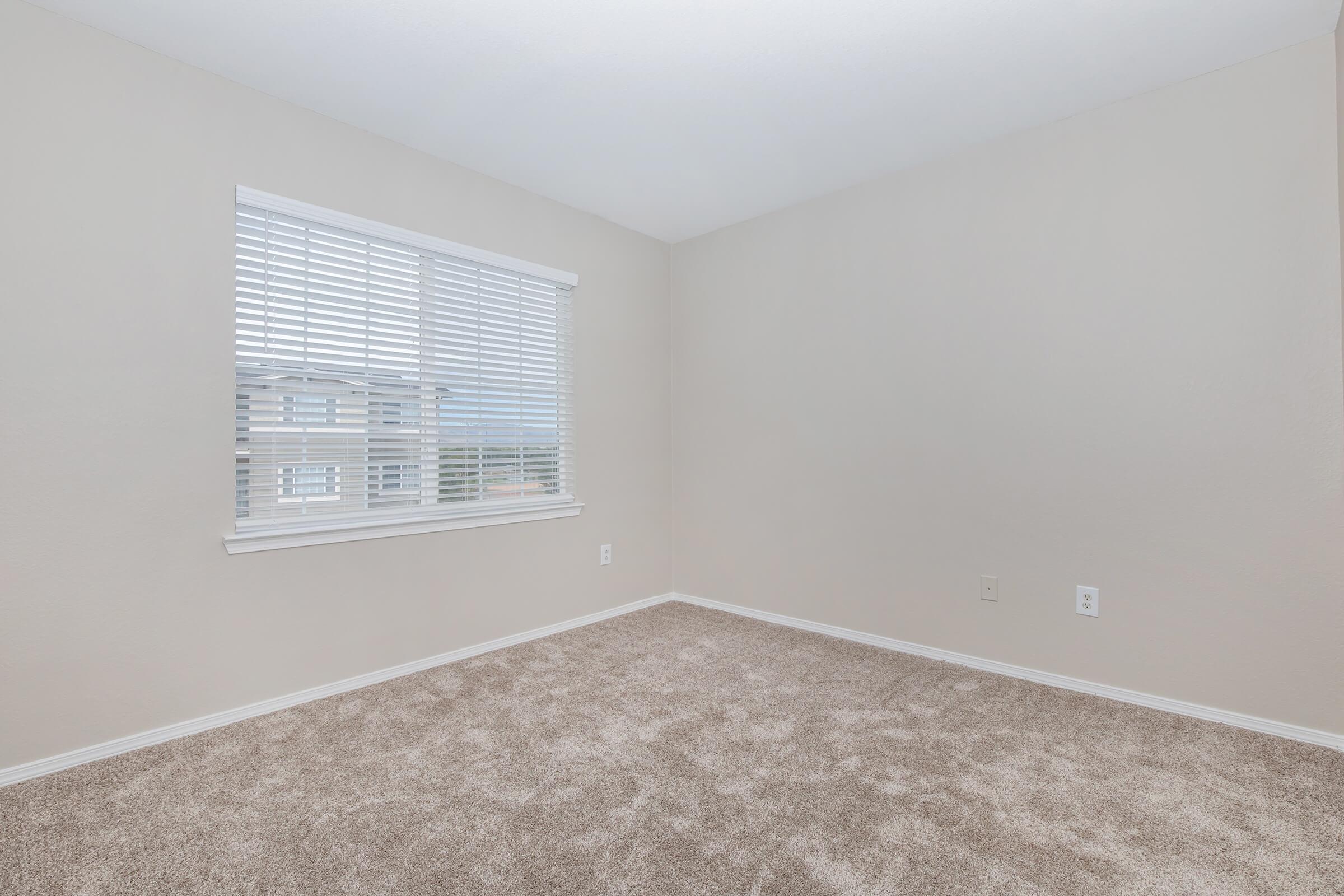 a bedroom with a large window