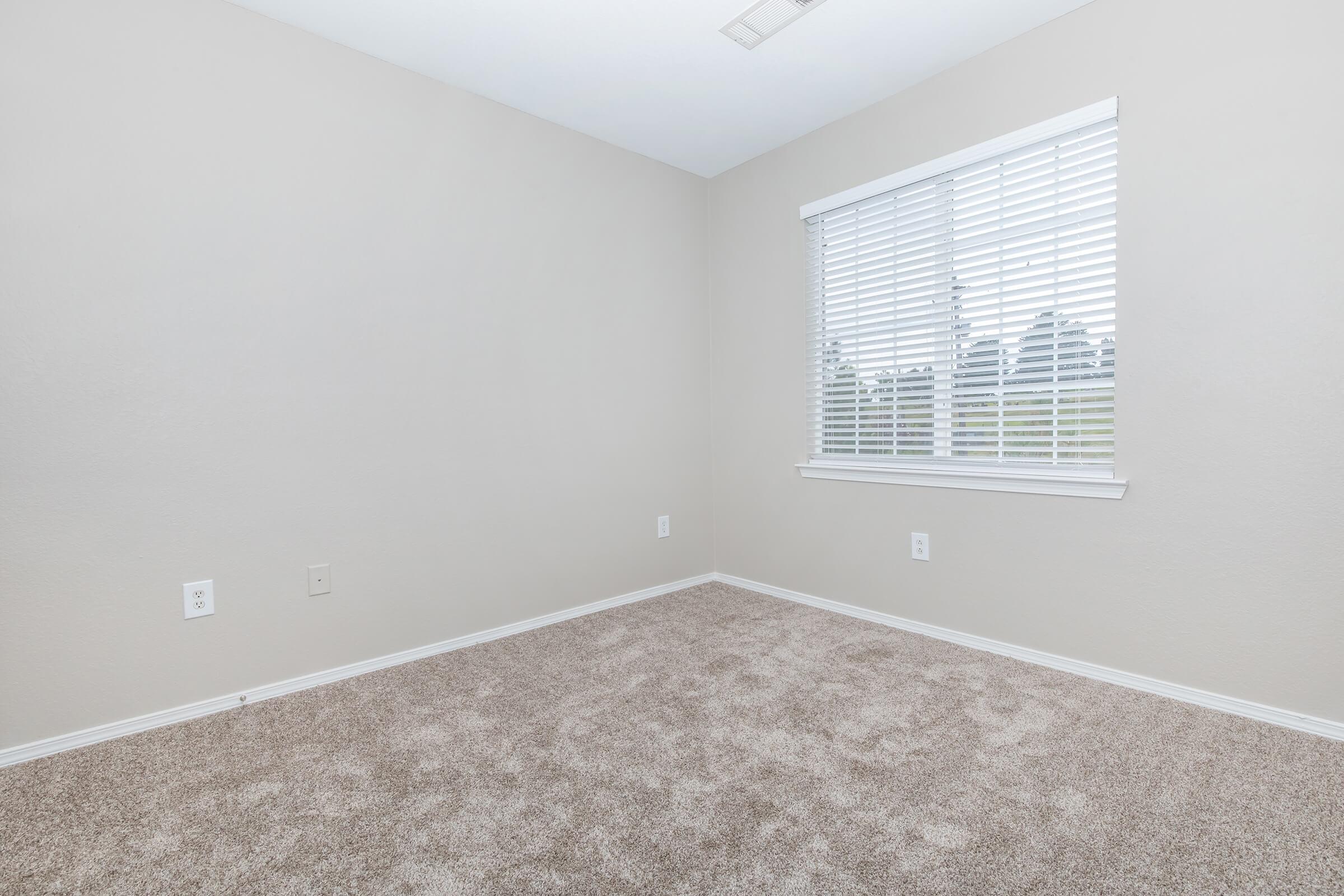 a bedroom with a large window