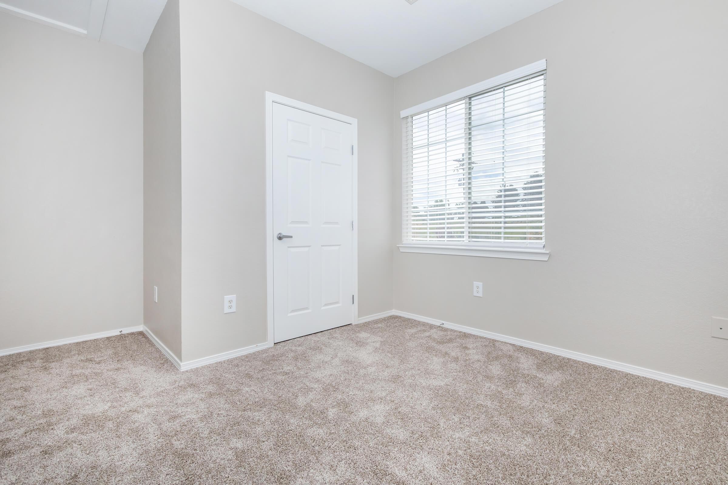 a bedroom with a large window