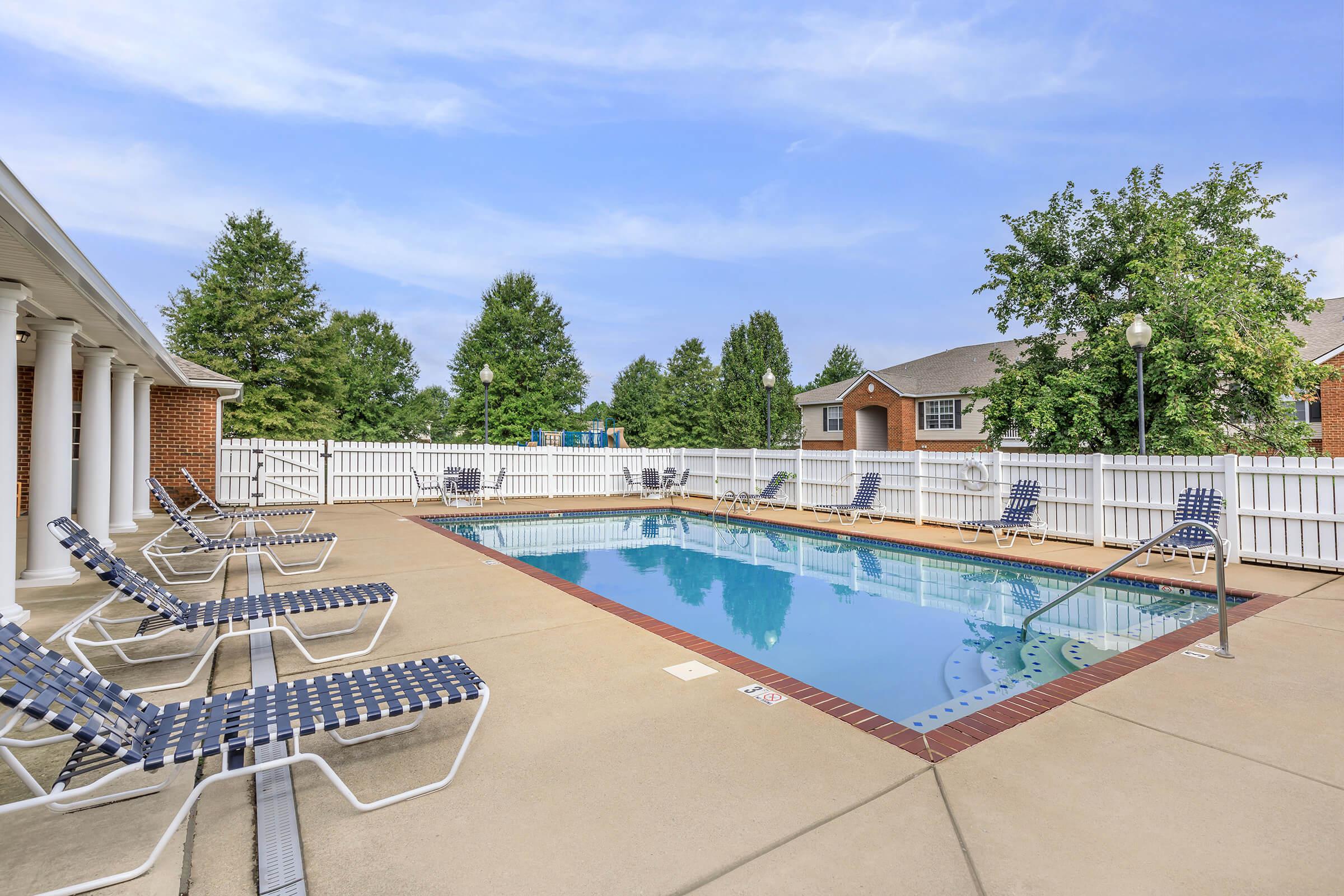 Lounge by the pool at Lakeshore Crossing Apartments