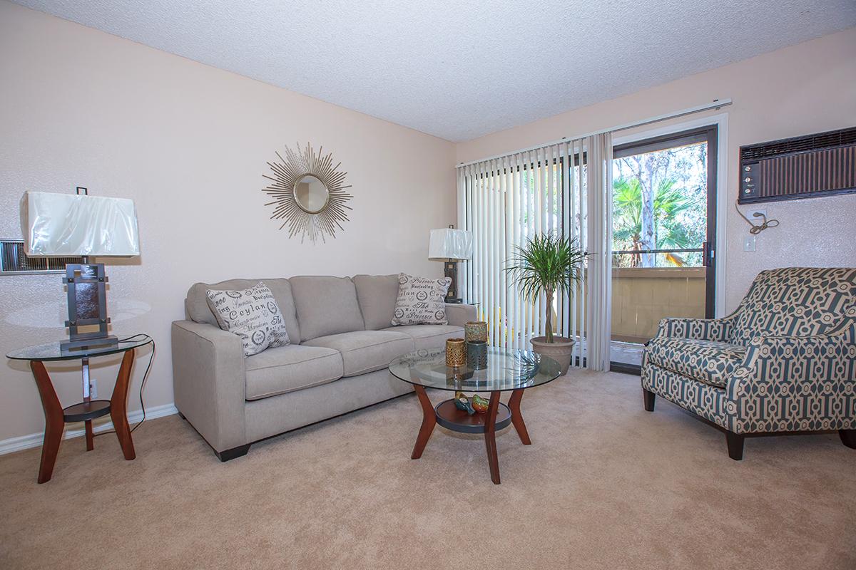 a living room filled with furniture and a large window