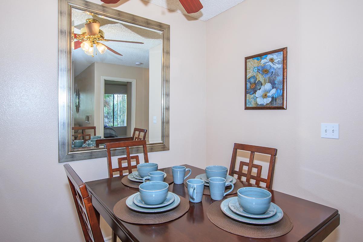 a room filled with furniture and vase on a table