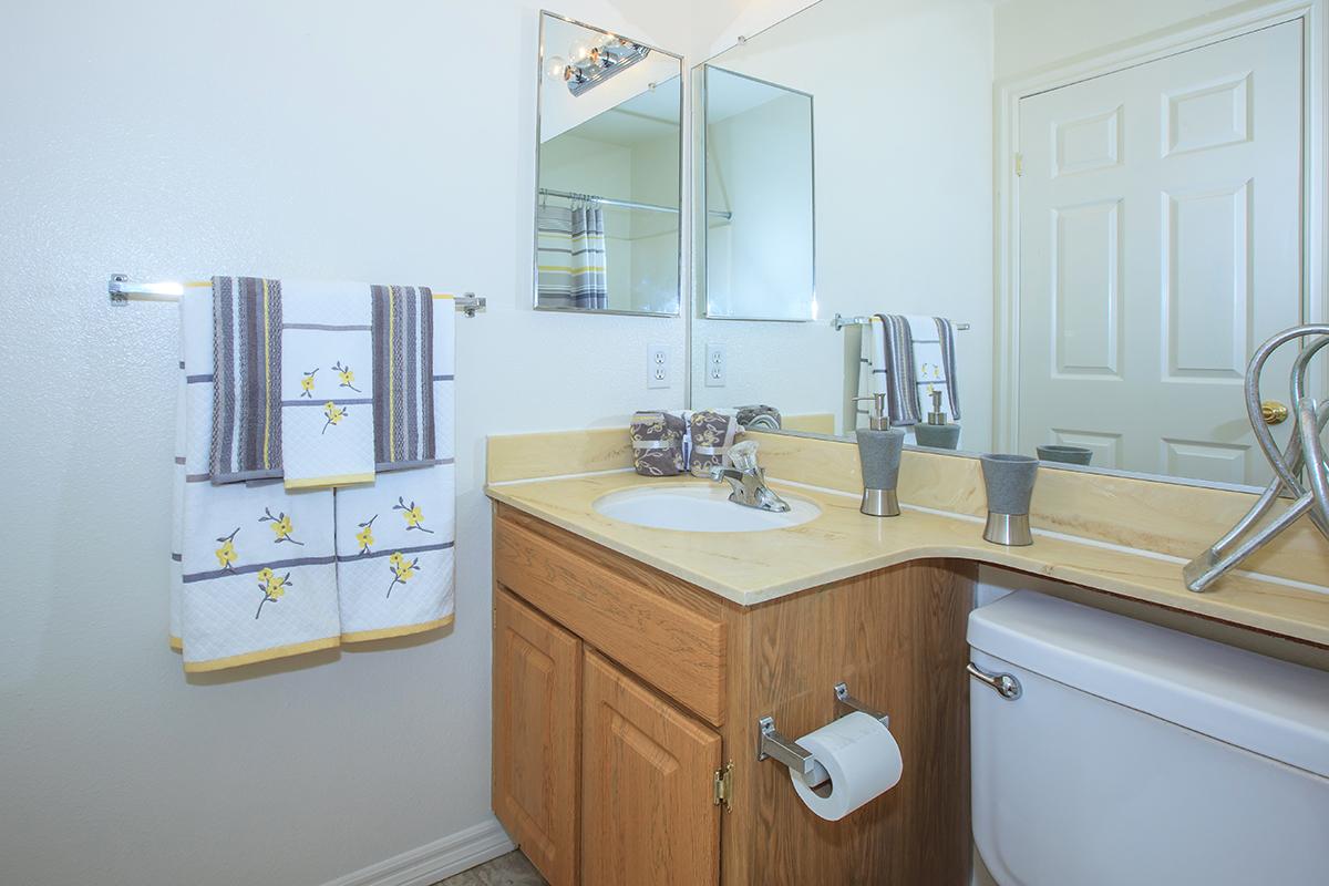 a kitchen with a sink and a mirror