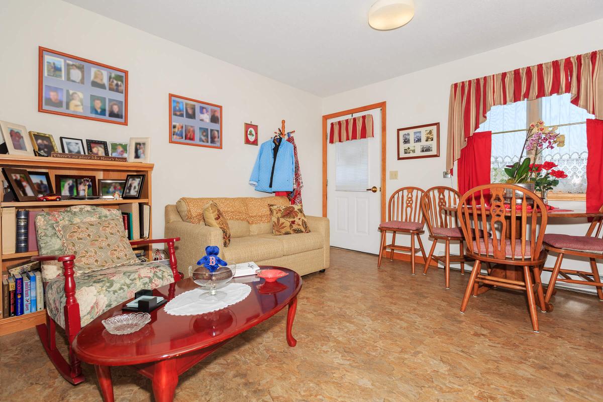 a living room filled with furniture and a red chair