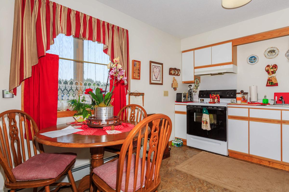 a kitchen with a red chair in a room