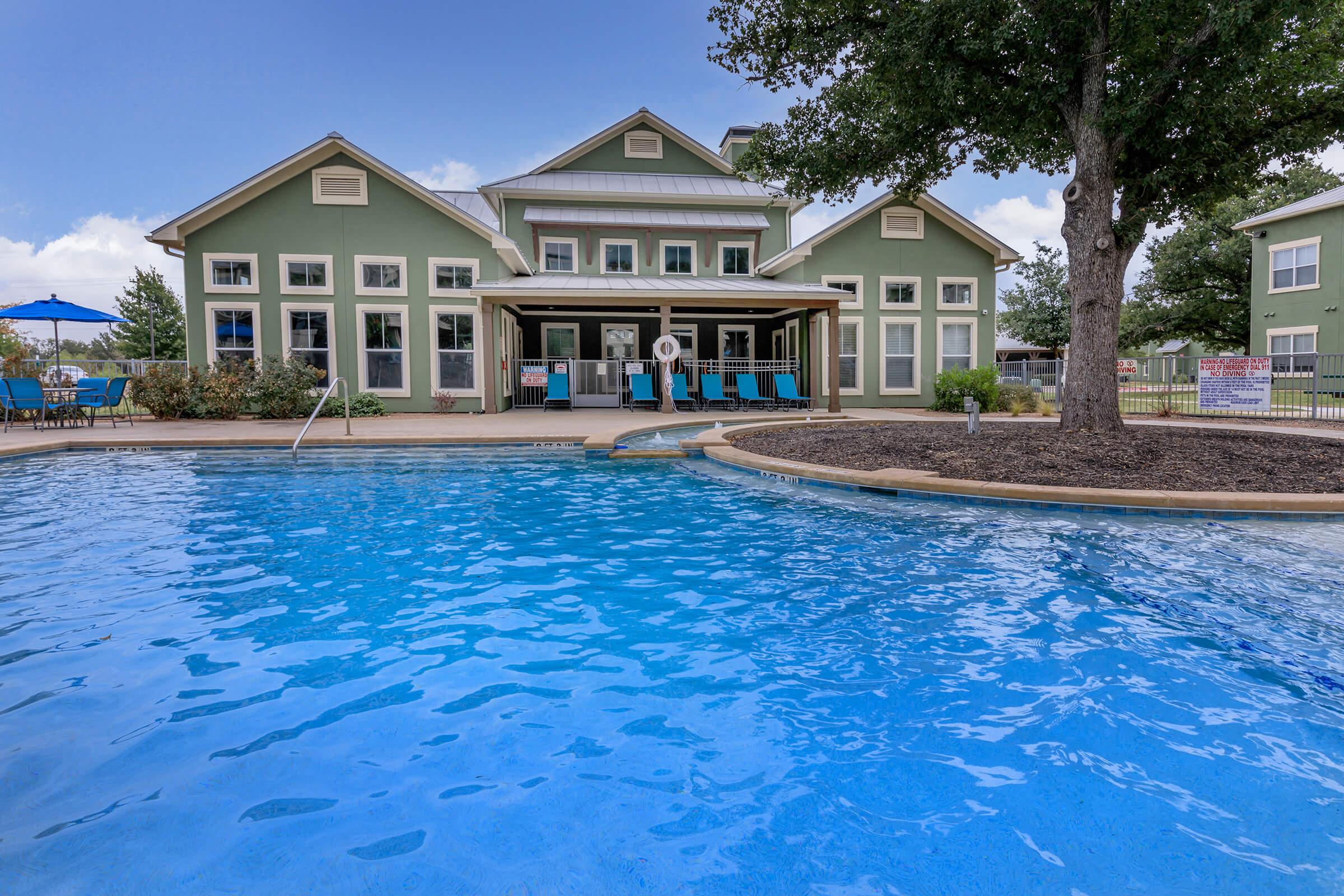 a large pool of water in front of a house