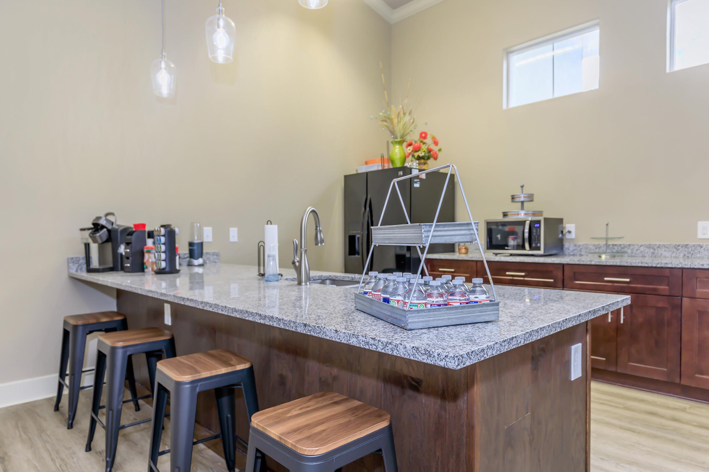 a kitchen with an island in the middle of a table