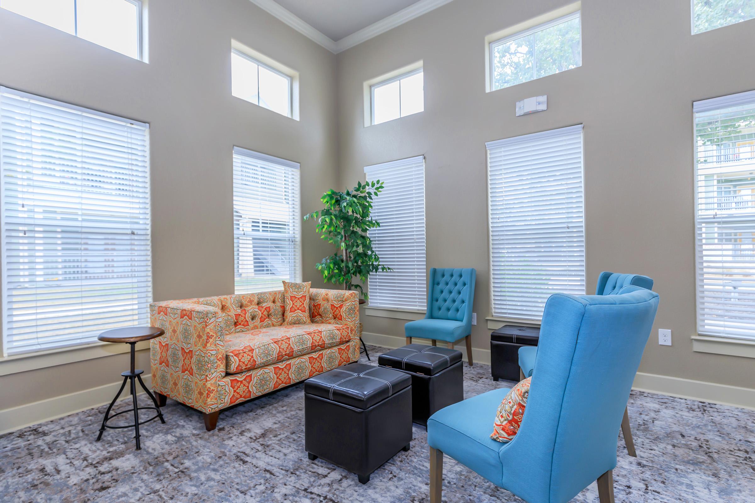 a living room filled with furniture and a large window