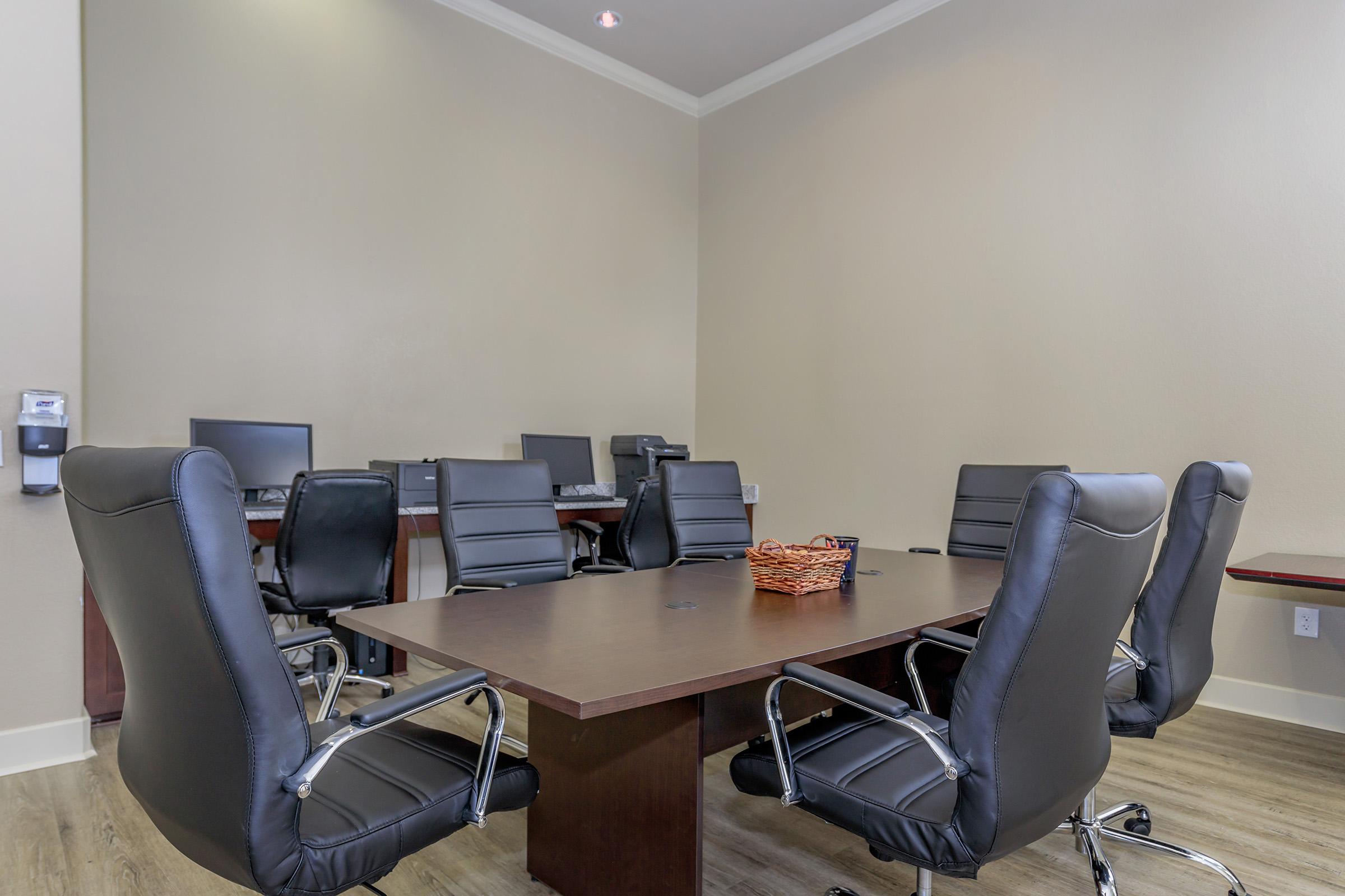 an office with a desk and chair in a room