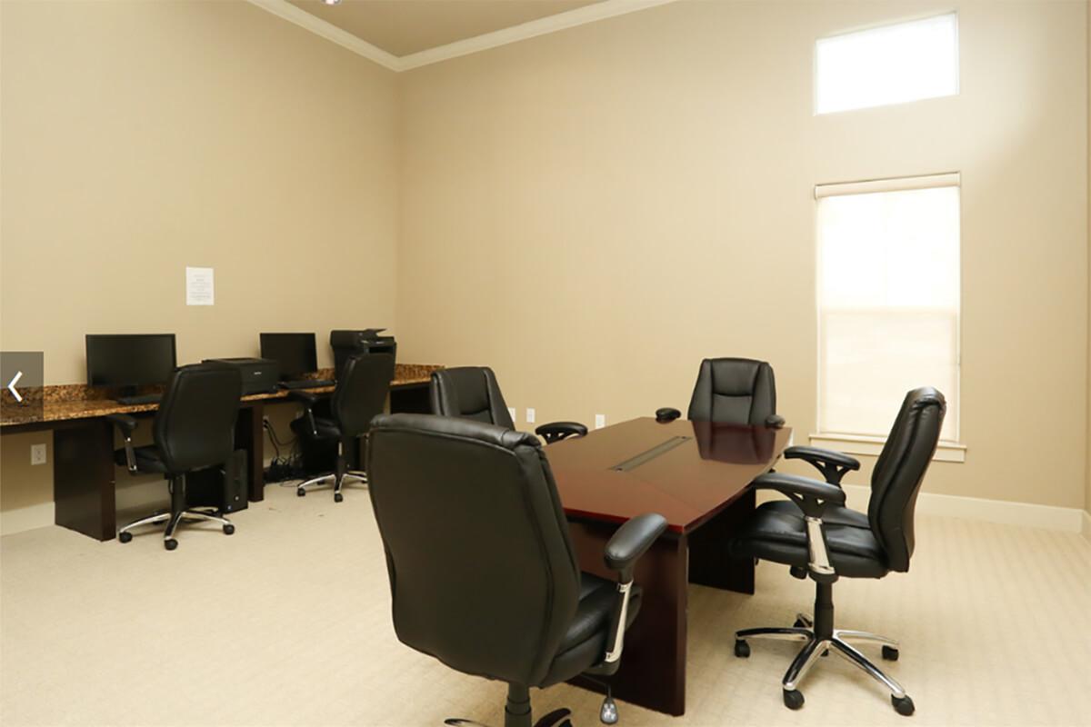 an office with a desk and chair in a room