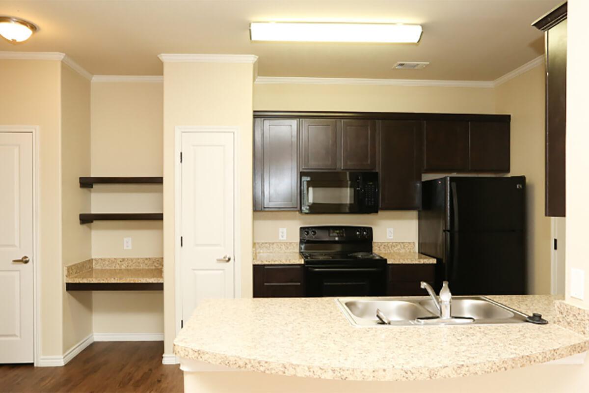 a kitchen with a sink and a mirror