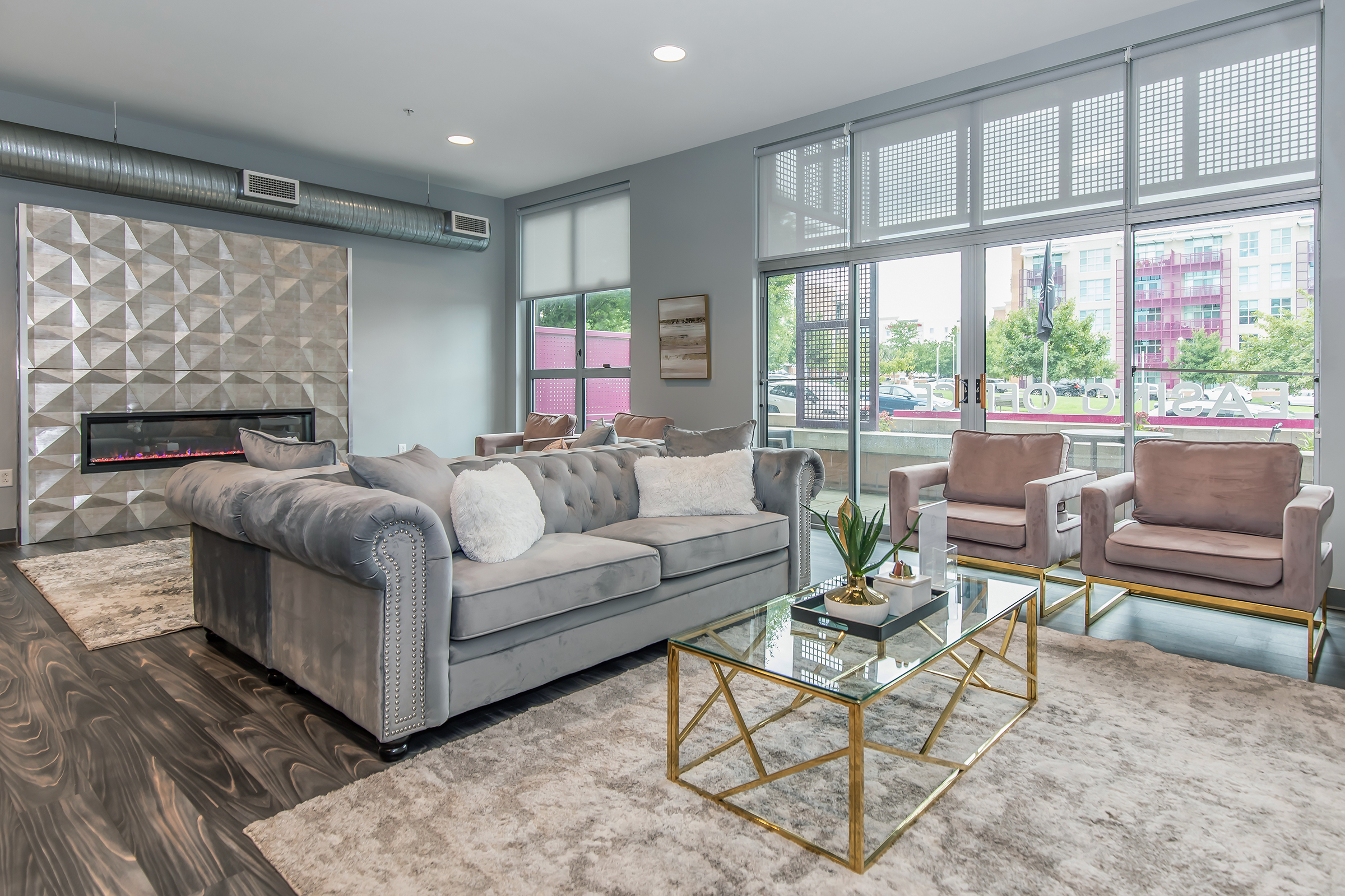 a living room filled with furniture and a large window