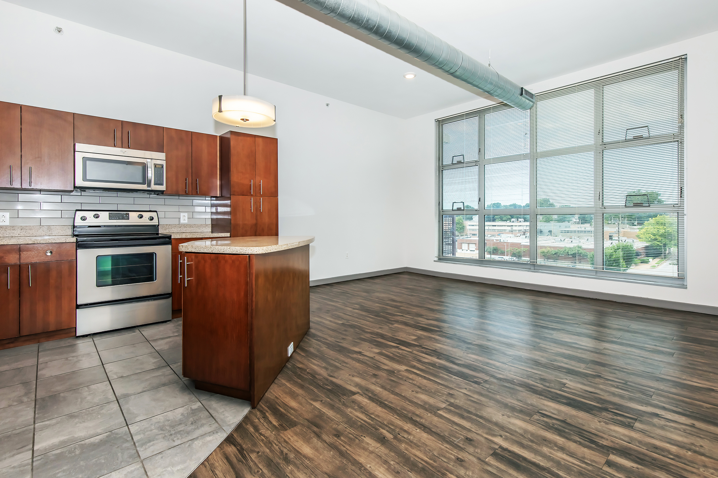 a kitchen with wooden cabinets and a wood floor