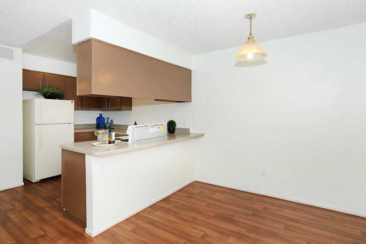 a kitchen with white appliances and wooden cabinets