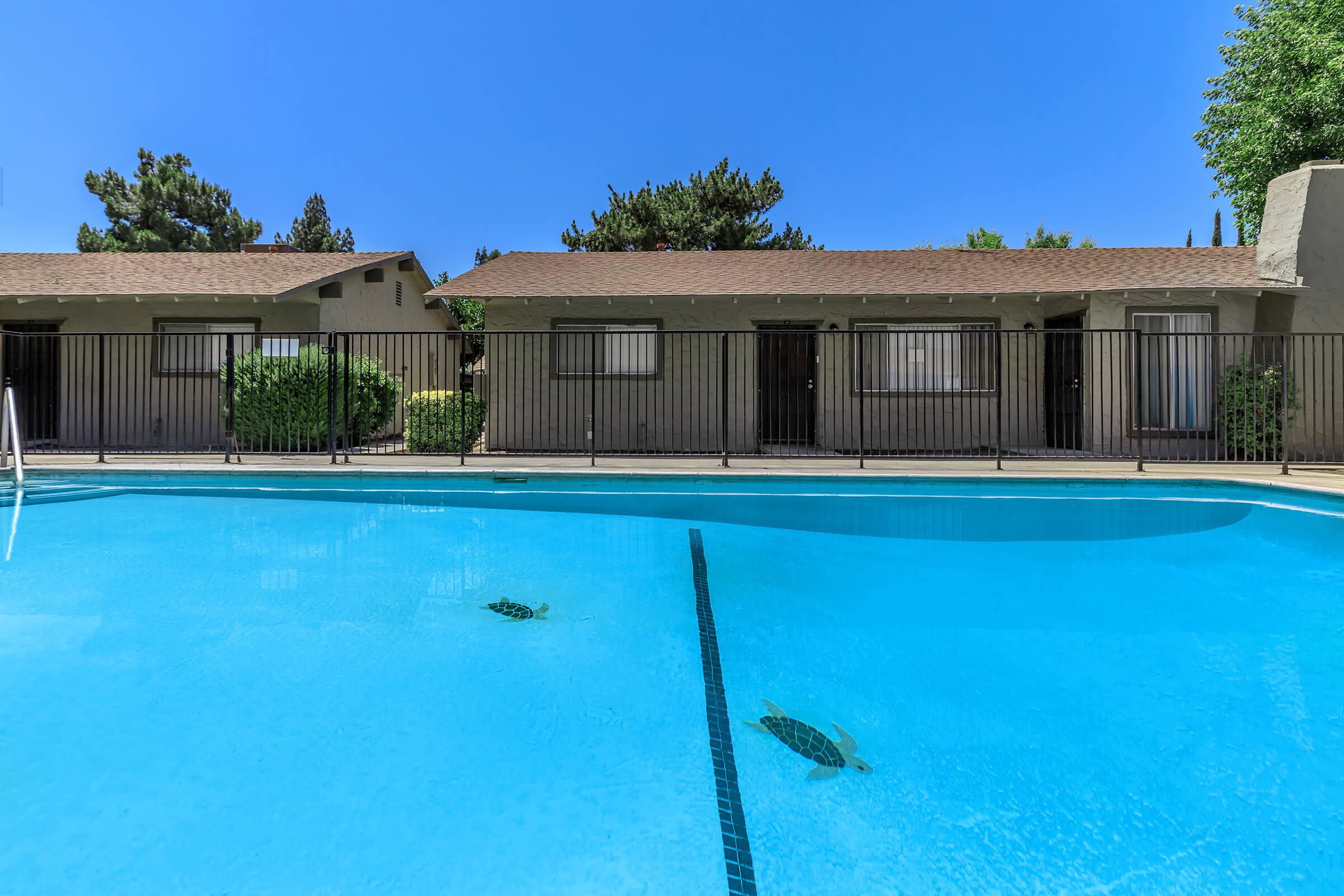 a blue pool of water in front of a building