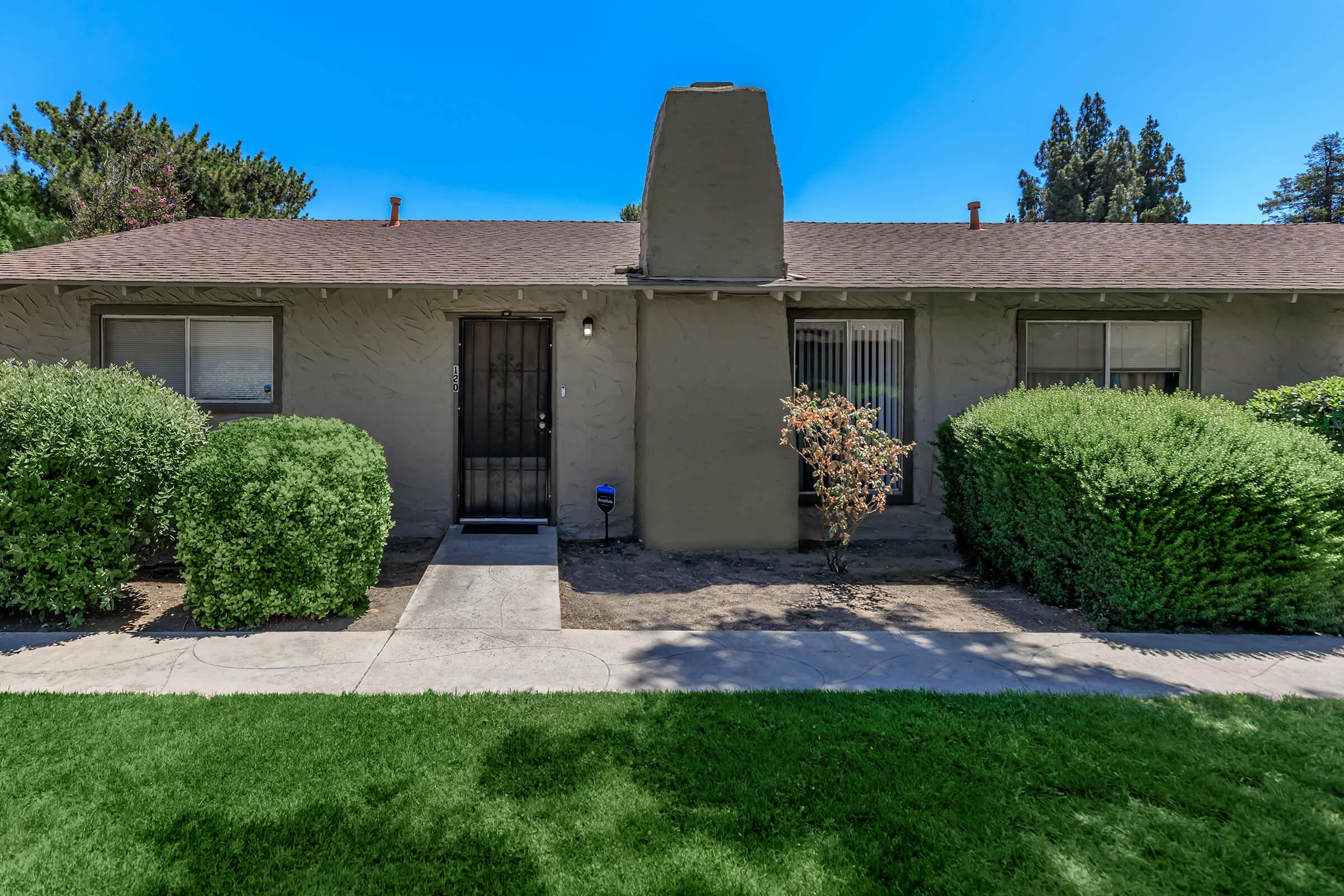 a house with a lawn in front of a building