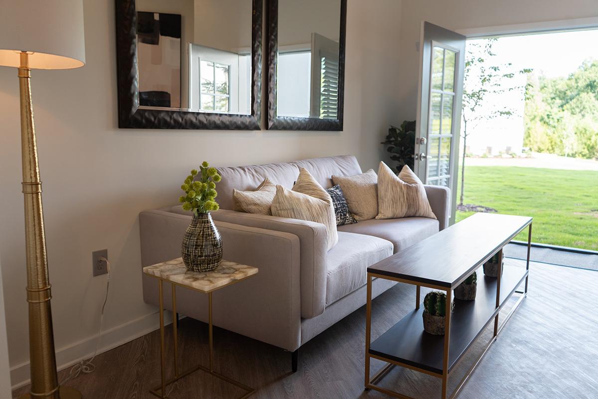 a living room filled with furniture and a large window