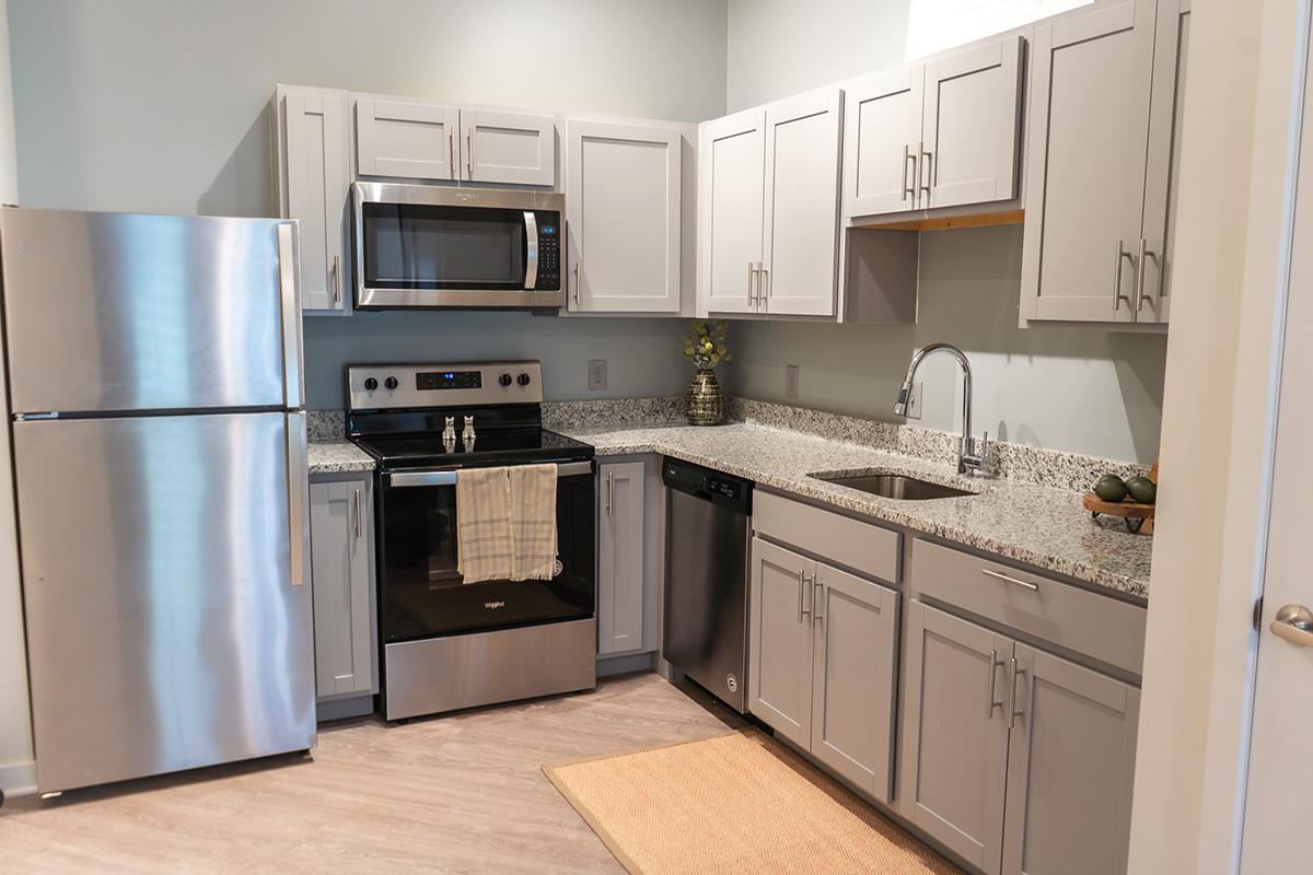 a kitchen with stainless steel appliances and wooden cabinets