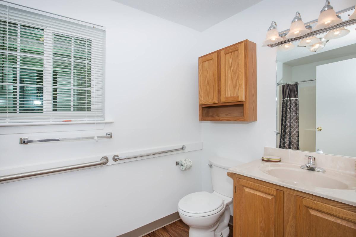 a large white tub next to a window