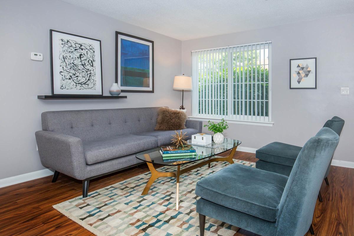 a living room filled with furniture and a fire place sitting in a chair