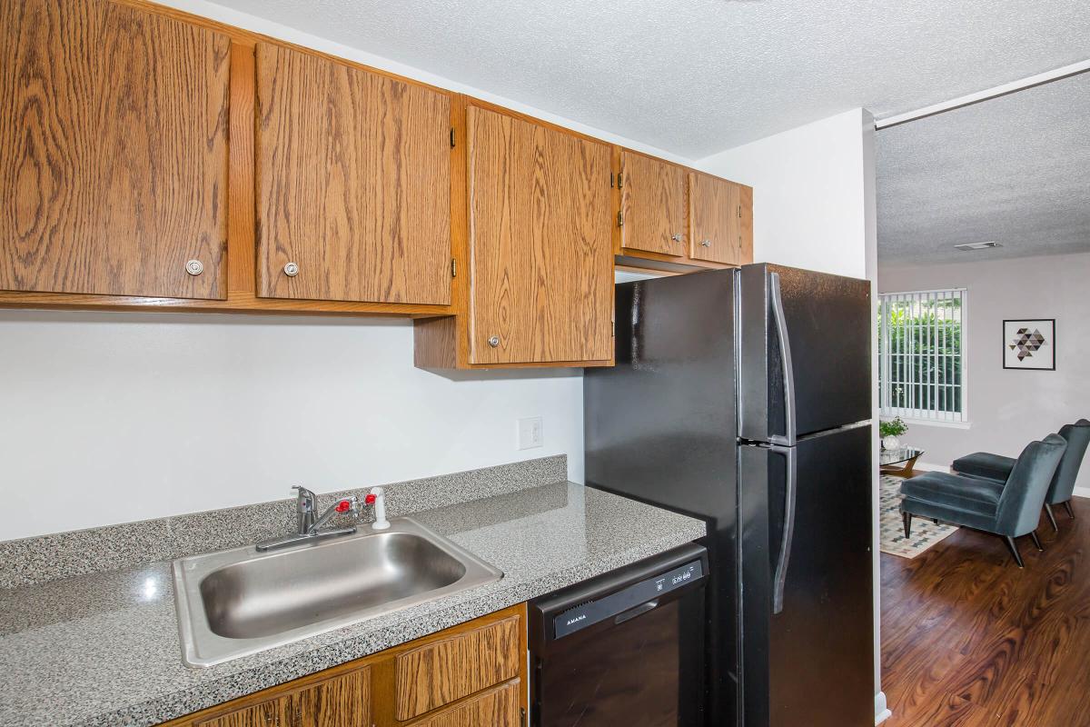 a kitchen with stainless steel appliances and wooden cabinets