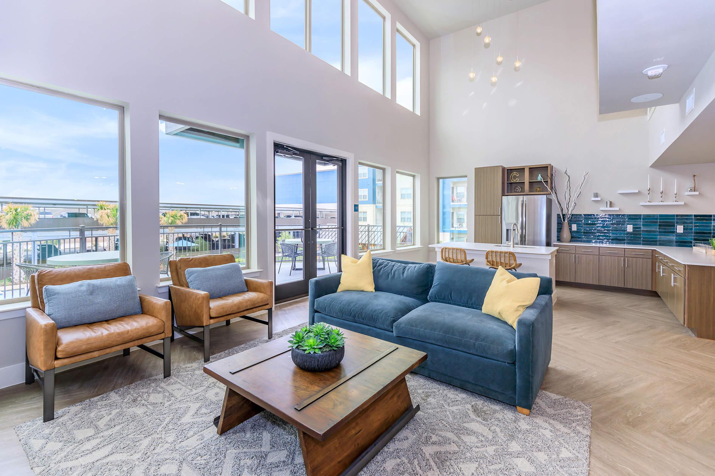 a living room filled with furniture and a large window